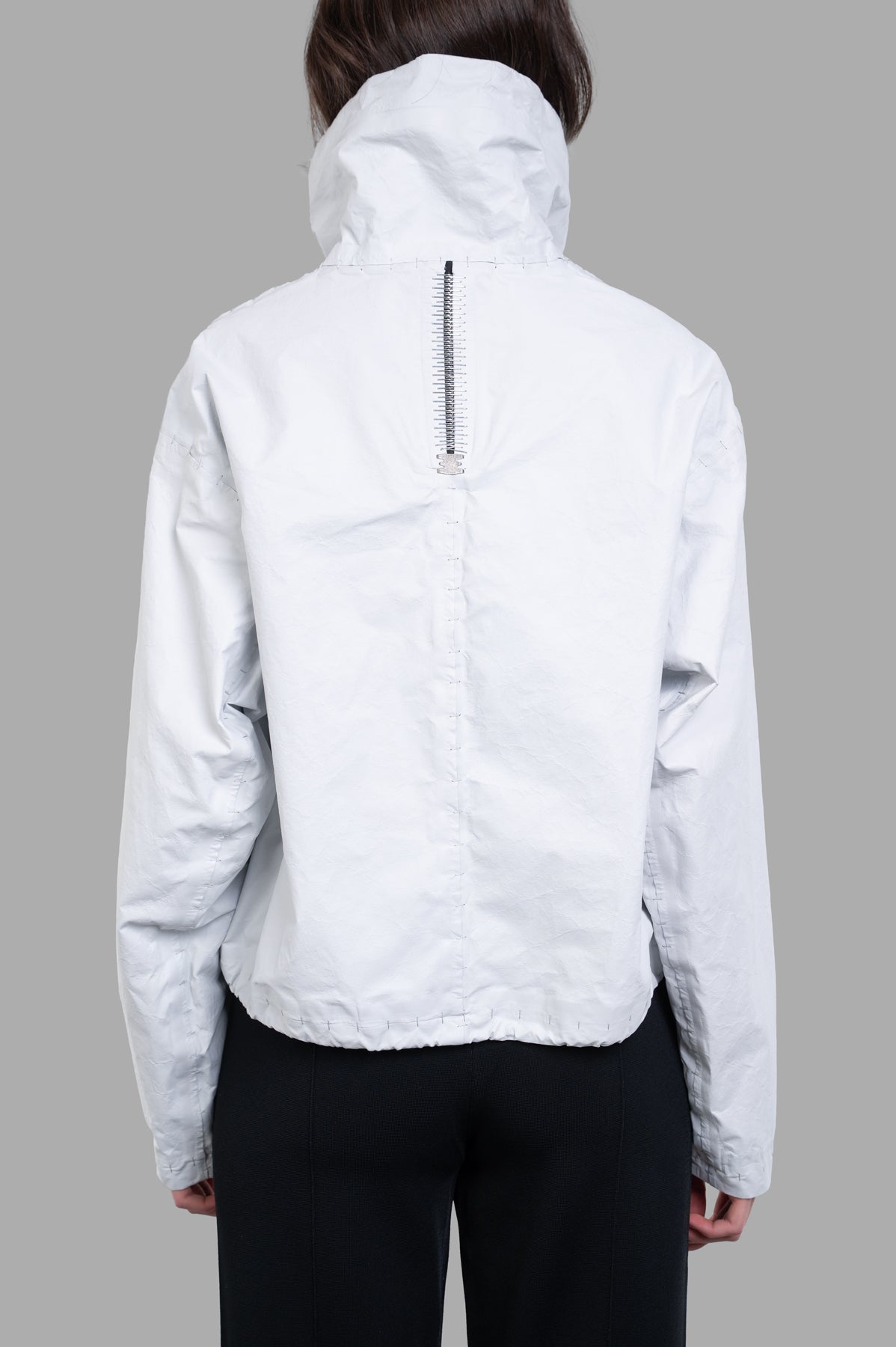 Isaac Sellam Cropped Windbreaker Jacket, off-white, shown from the back highlighting spine zipper and textured fabric.
