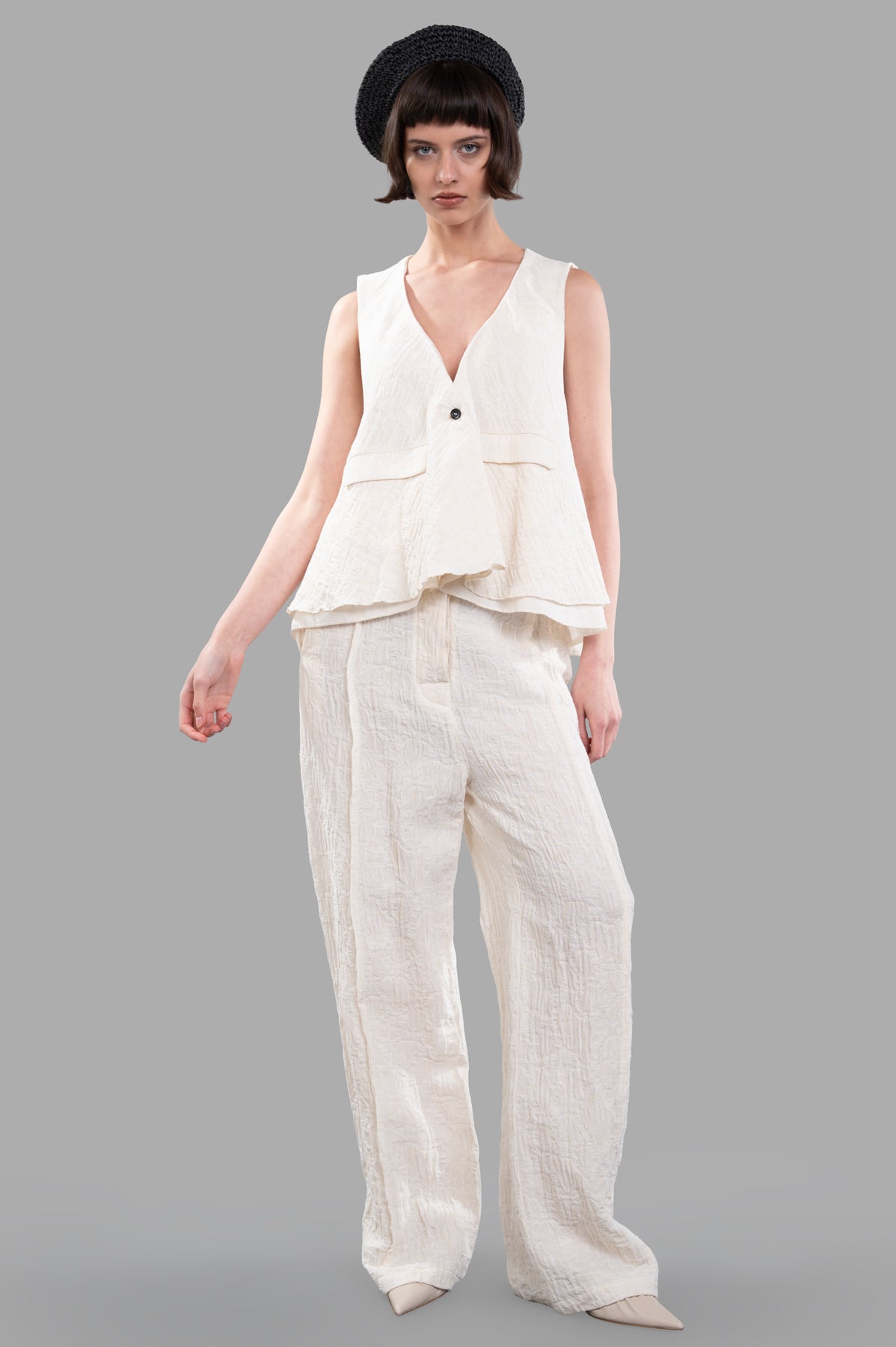 Marc Point Textured Vest in ecru, A-line cut and V-neck. Features crinkled fabric, styled with matching pants, front view.