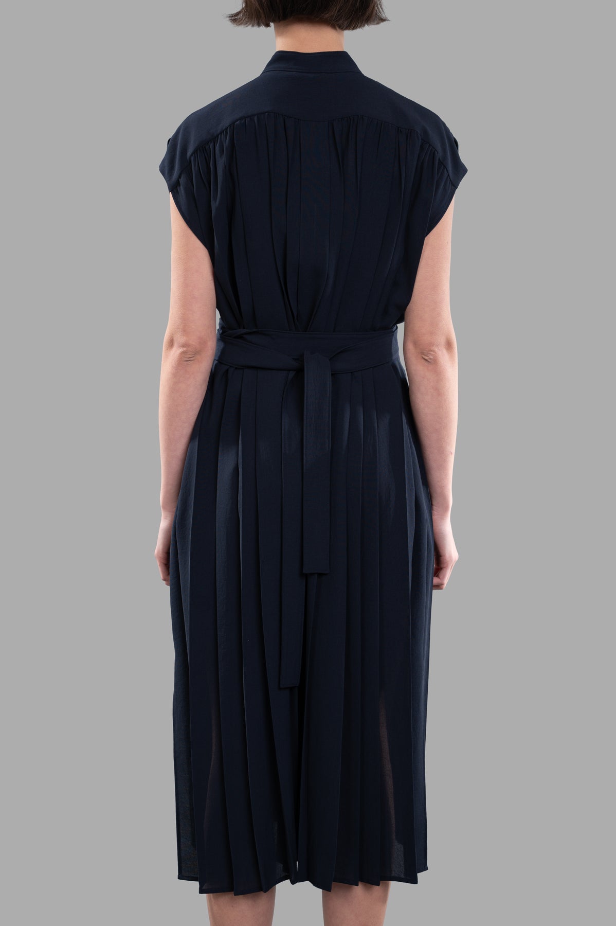 Joseph Davidge Airy Plissé Dress in dark blue, showcasing the relaxed fit and button-up design from the back view.