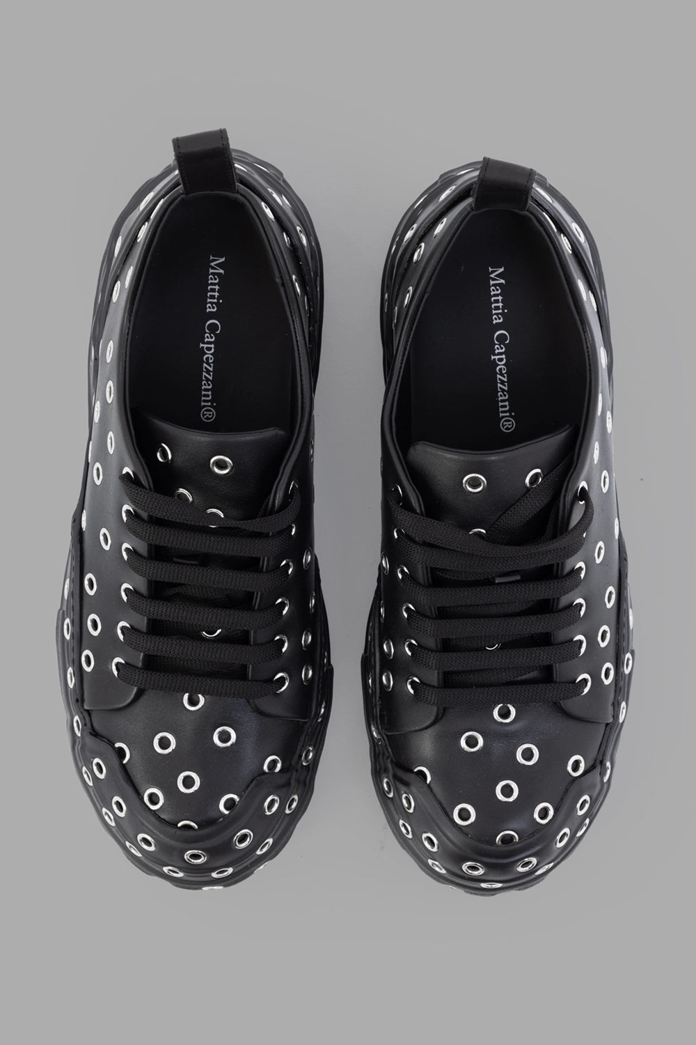 Mattia Capezzani sneakers in black, back view, heel pull tabs and eyelet-wrapped sole