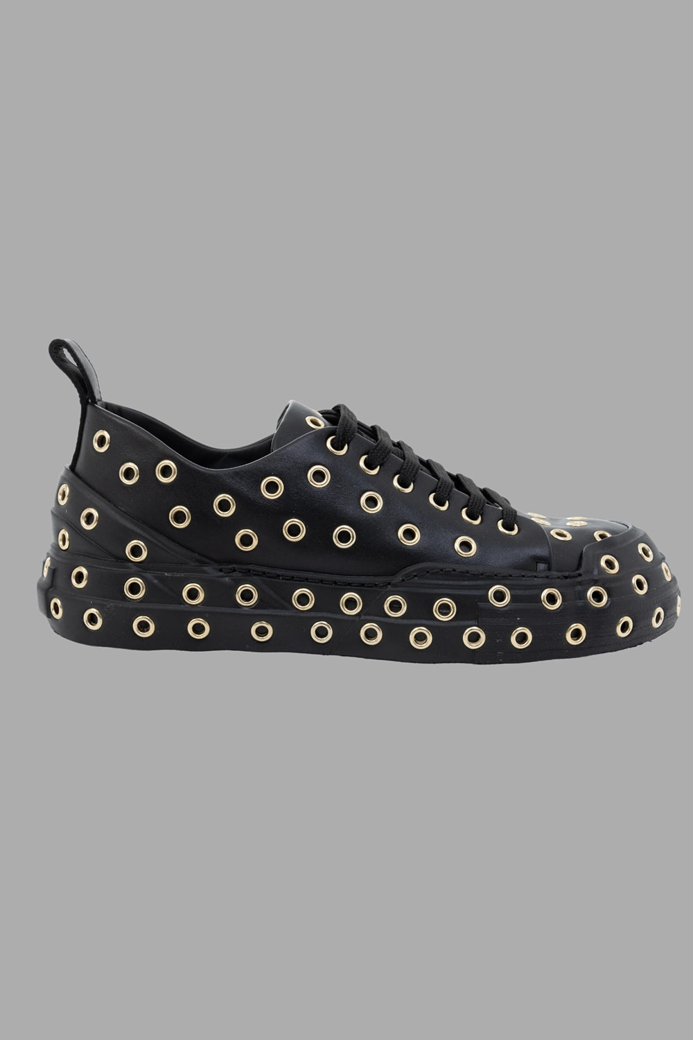 Mattia Capezzani women leather sneakers in black, side view, gold-tone eyelet pattern and chunky rubber sole.