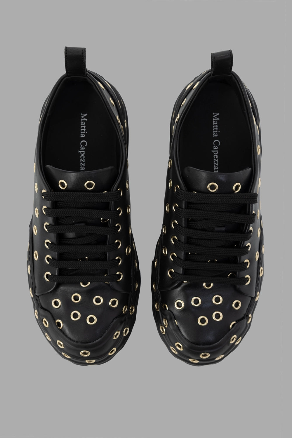 Mattia Capezzani women leather sneakers in black, top view, round toe with all-over eyelets and tonal laces.