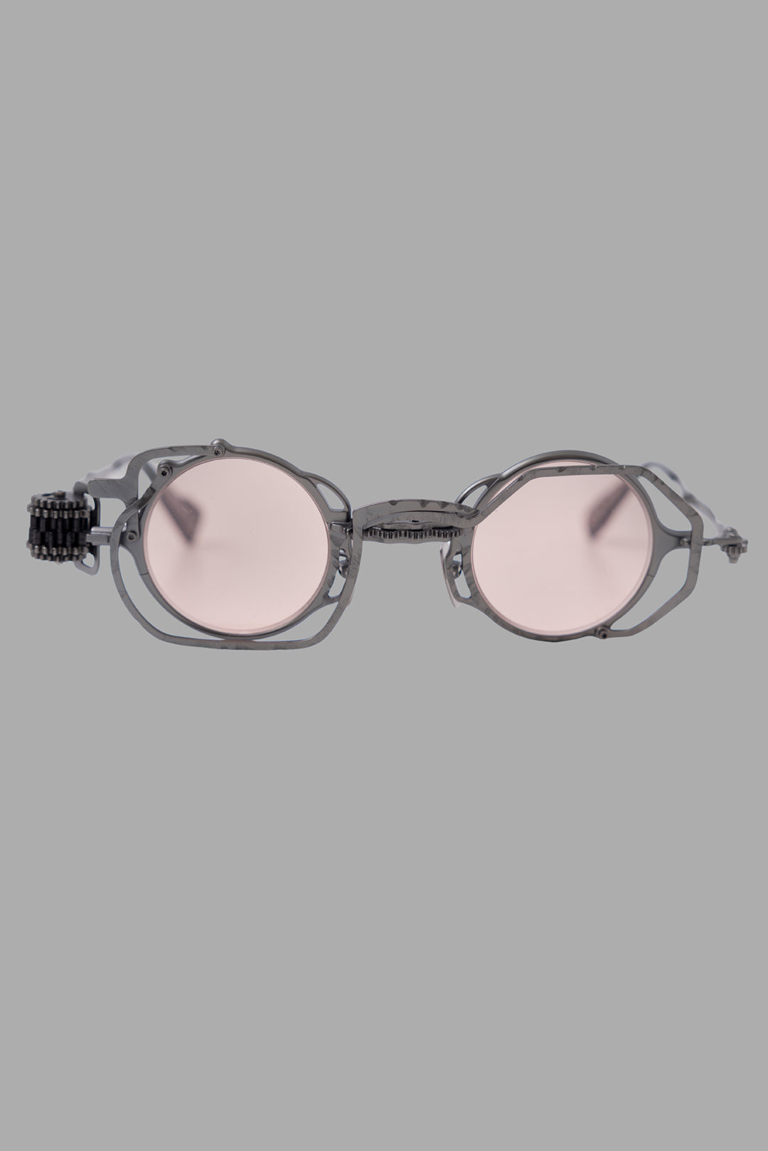 Kuboraum unisex gunmetal sunglasses with light pink lenses, front view with round frames and hammered exoskeleton.