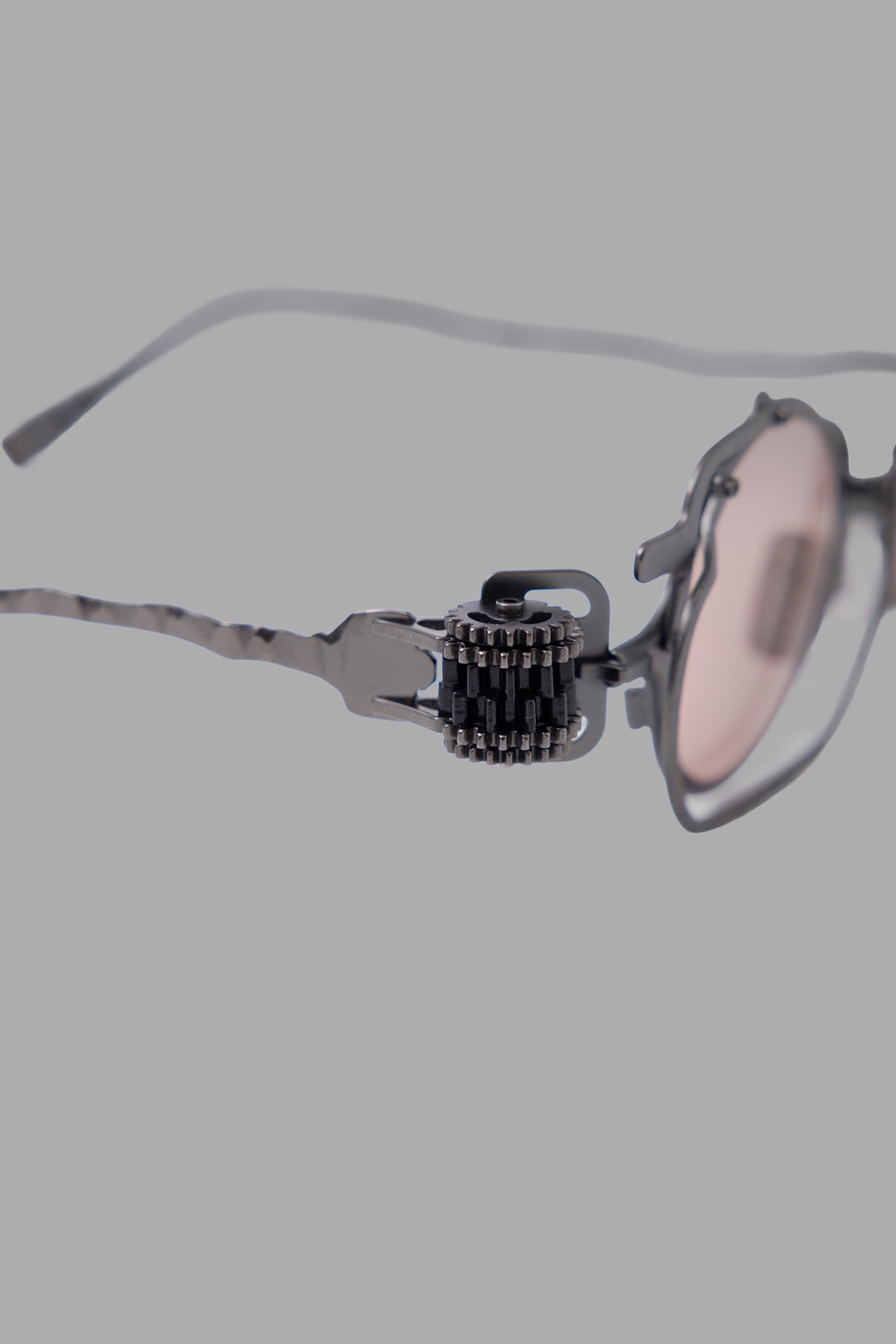 Kuboraum unisex gunmetal sunglasses, close-up of side gear hinge detail and layered metal frame.