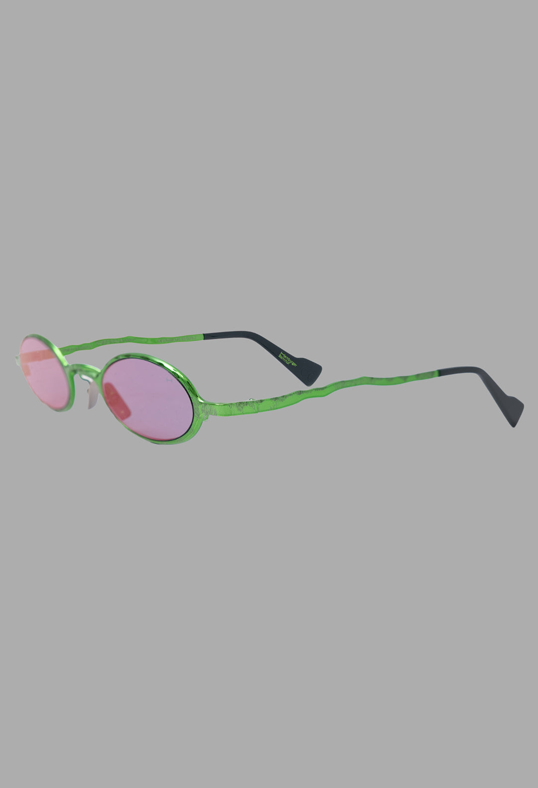 Kuboraum unisex metallic acid green micro oval sunglasses, three-quarter view with hammered metal frame and acetate tips.