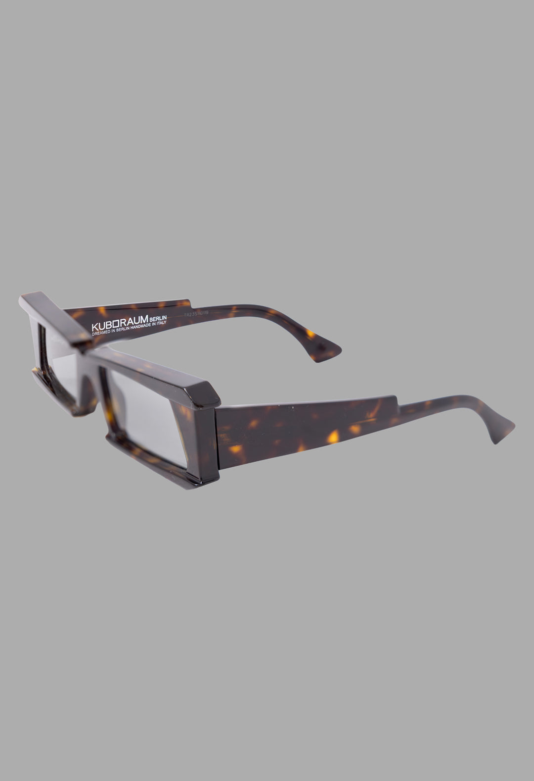 Kuboraum unisex tortoise rectangular sunglasses, 3/4 view, thick Mazzucchelli acetate frame with angled temples.