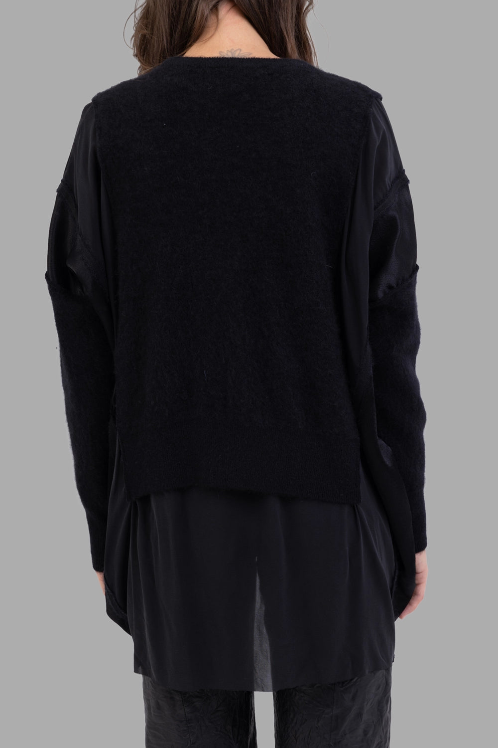 Giovanni Cavagna women layered knit sweater in black, back view, long underlayer panel and relaxed drape