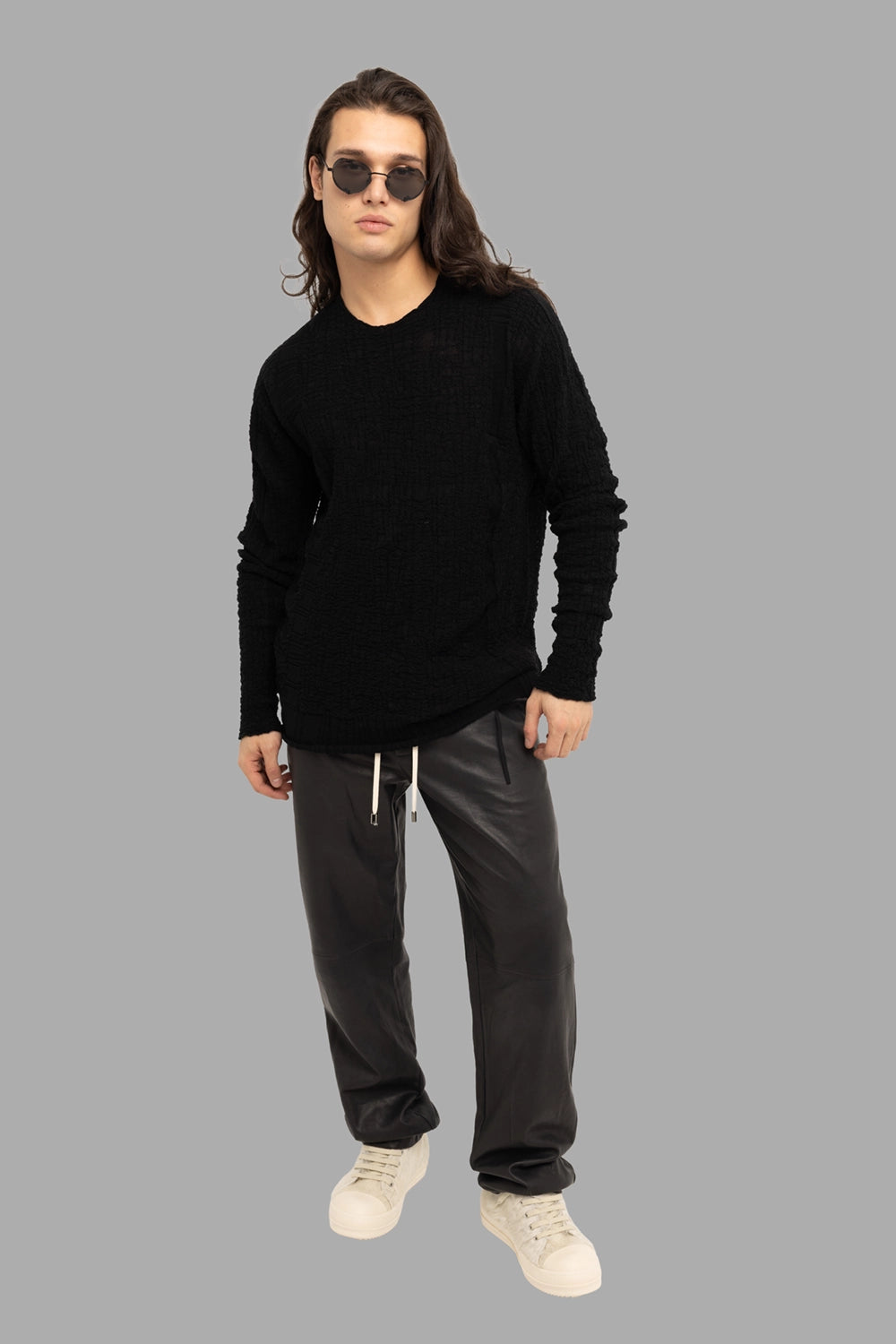 MD75 men’s sweater in black, on-model full length, semi-sheer textured knit with ribbed hem