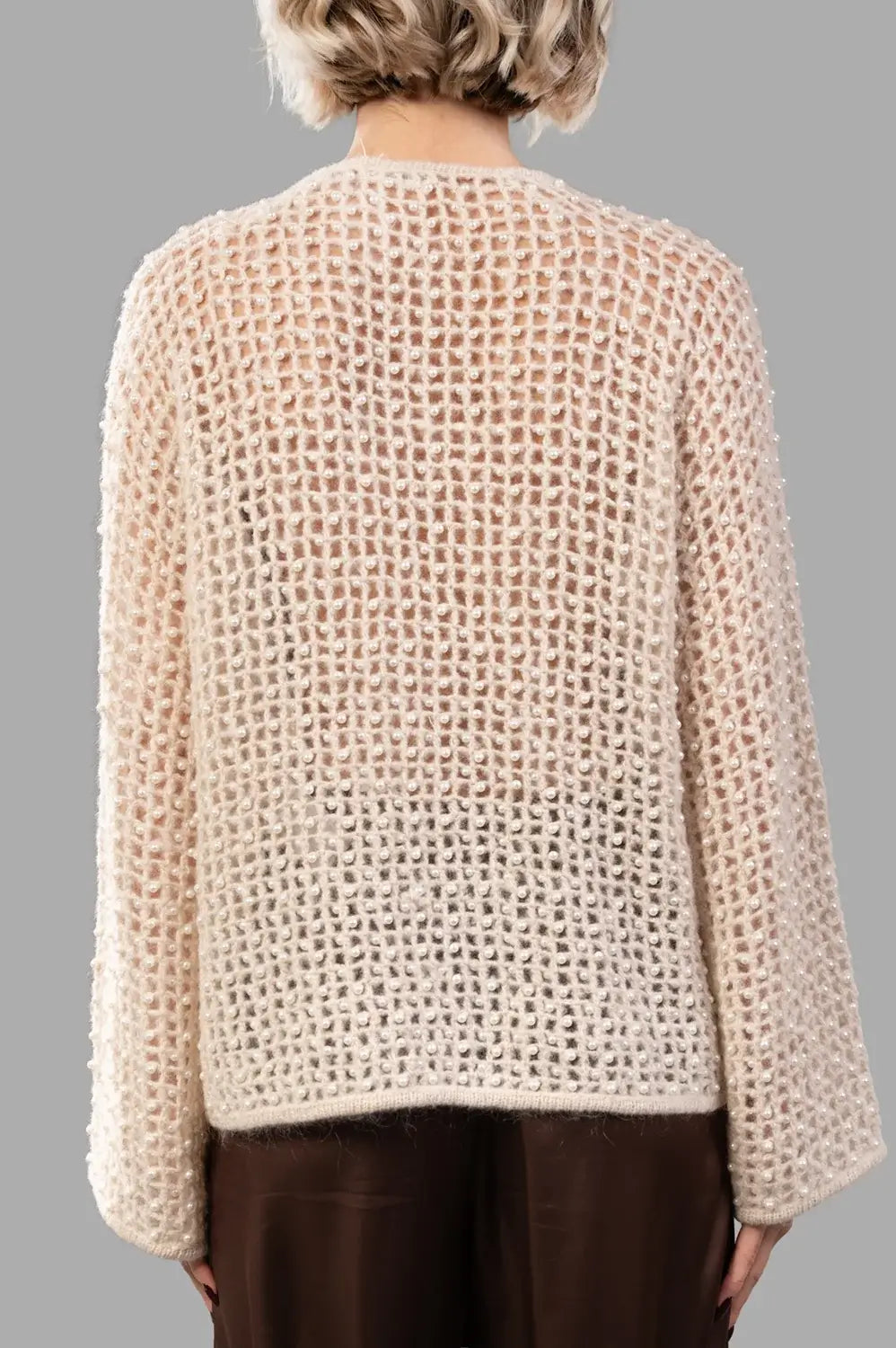 Back view of open-knit pearl sweater with relaxed fit and fine rib trims