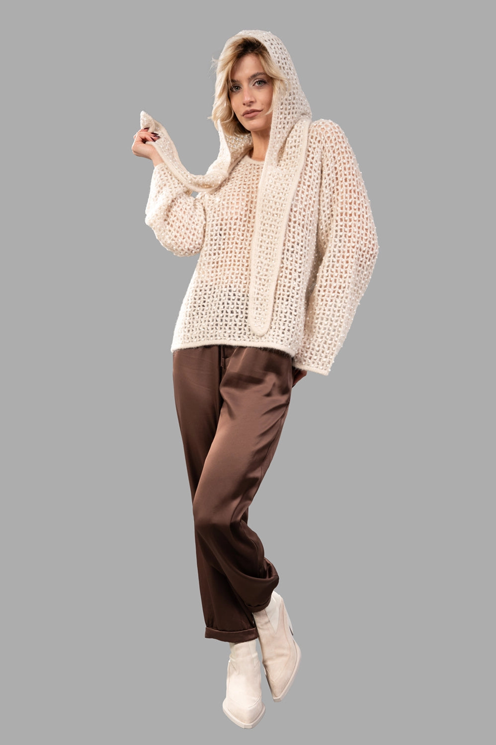 Open-knit pearl-embellished sweater in oyster gray on model, relaxed fit with wide sleeves and round neck