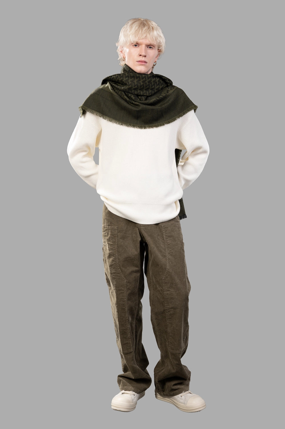 Model in white ribbed V-neck sweater, full-length view, relaxed fit