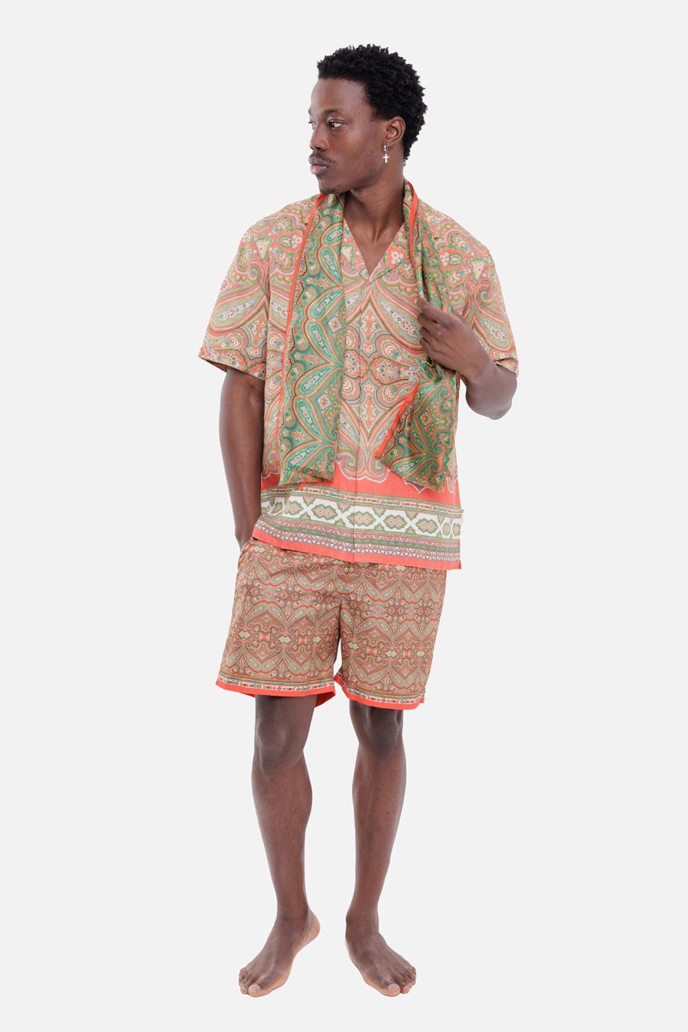 Orlebar Brown men's swim shorts in Vermillion, on-model full length with matching paisley shirt and red hem