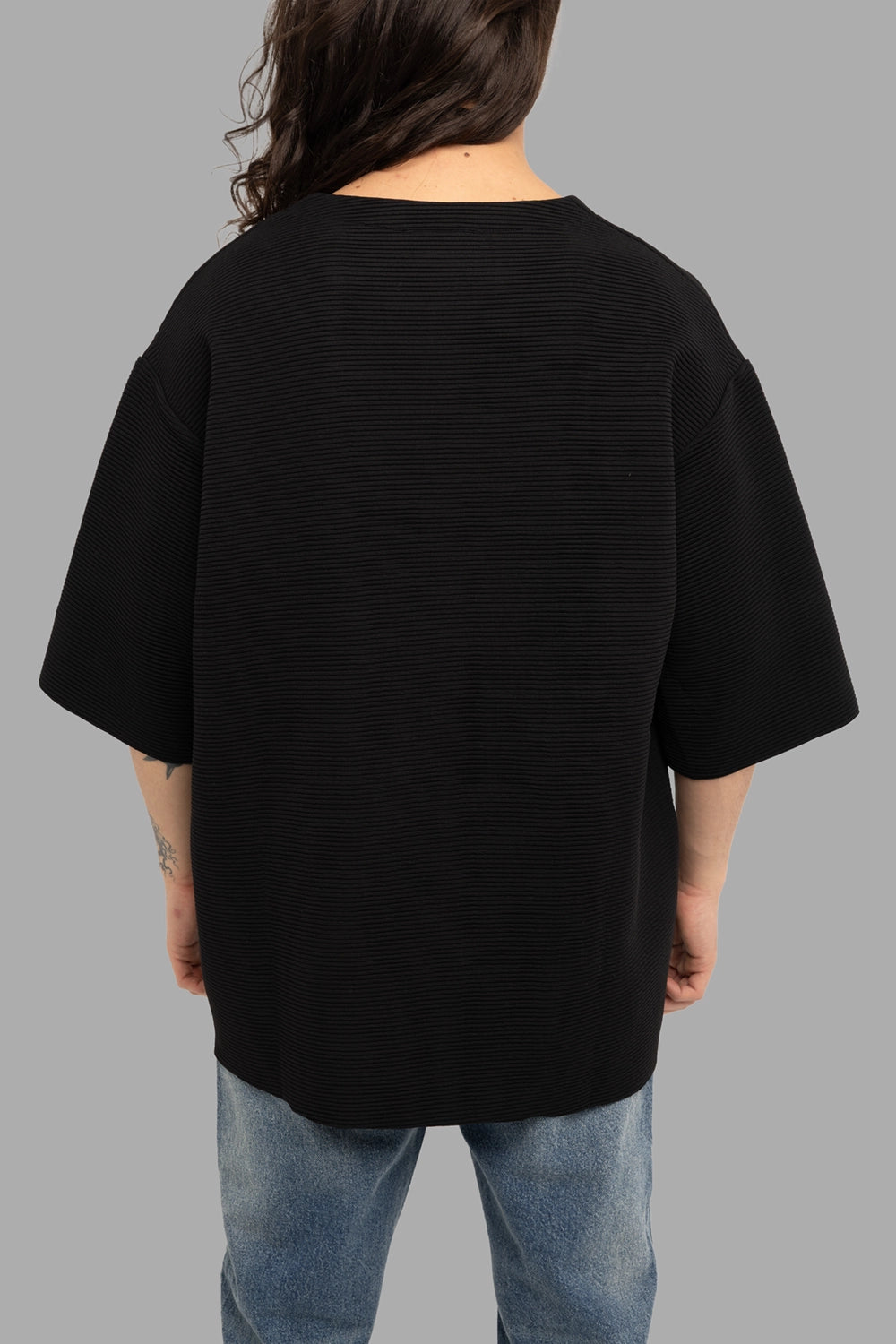 Gaelle Paris men’s t-shirt in black, back view, ribbed texture with relaxed drape and wide sleeves