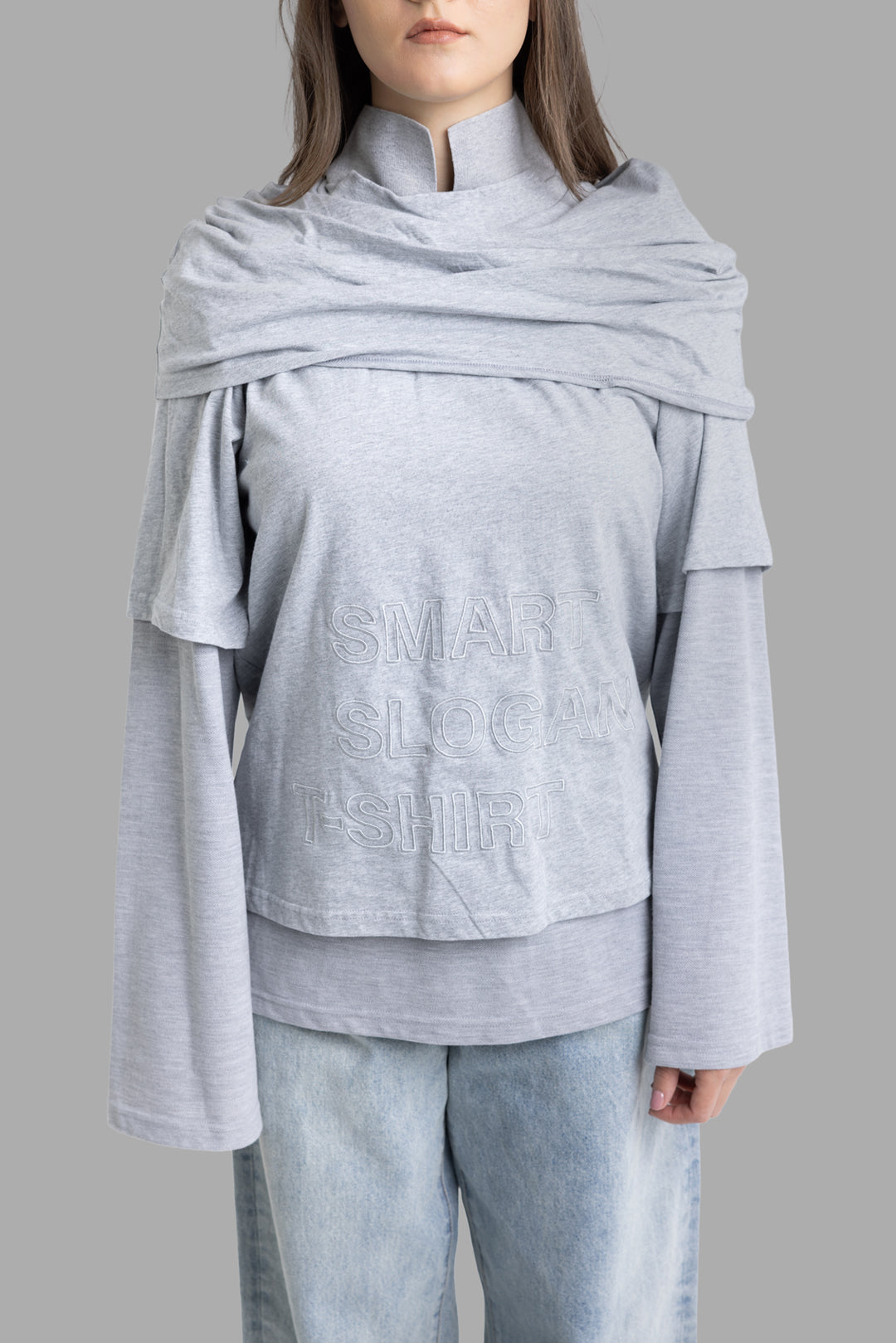 Natasha Zinko women's grey long sleeve T-shirt, front half-length view with stand collar and tonal slogan embroidery