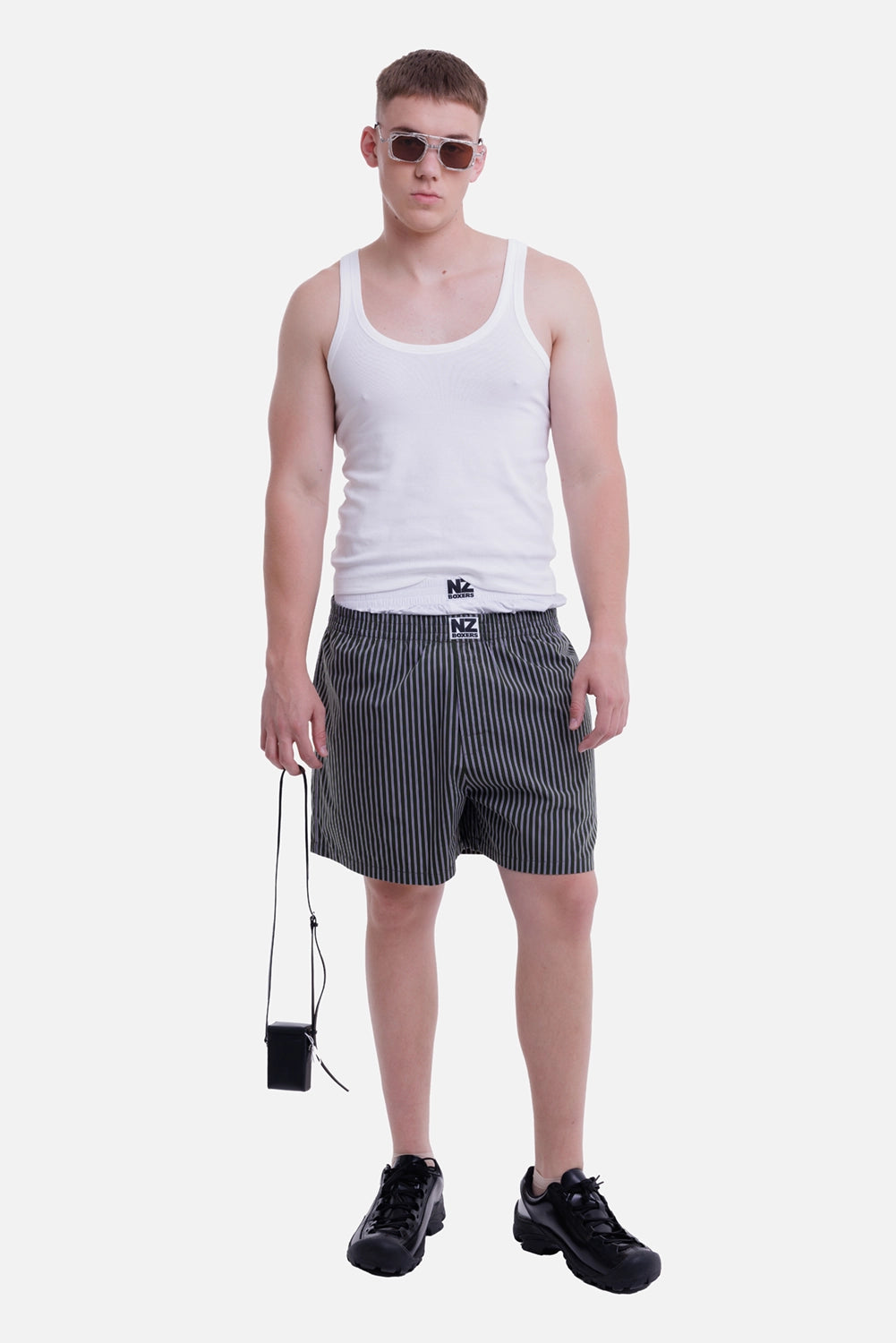 Natasha Zinko men's white tank top, full-length model view with scoop neck and fitted silhouette