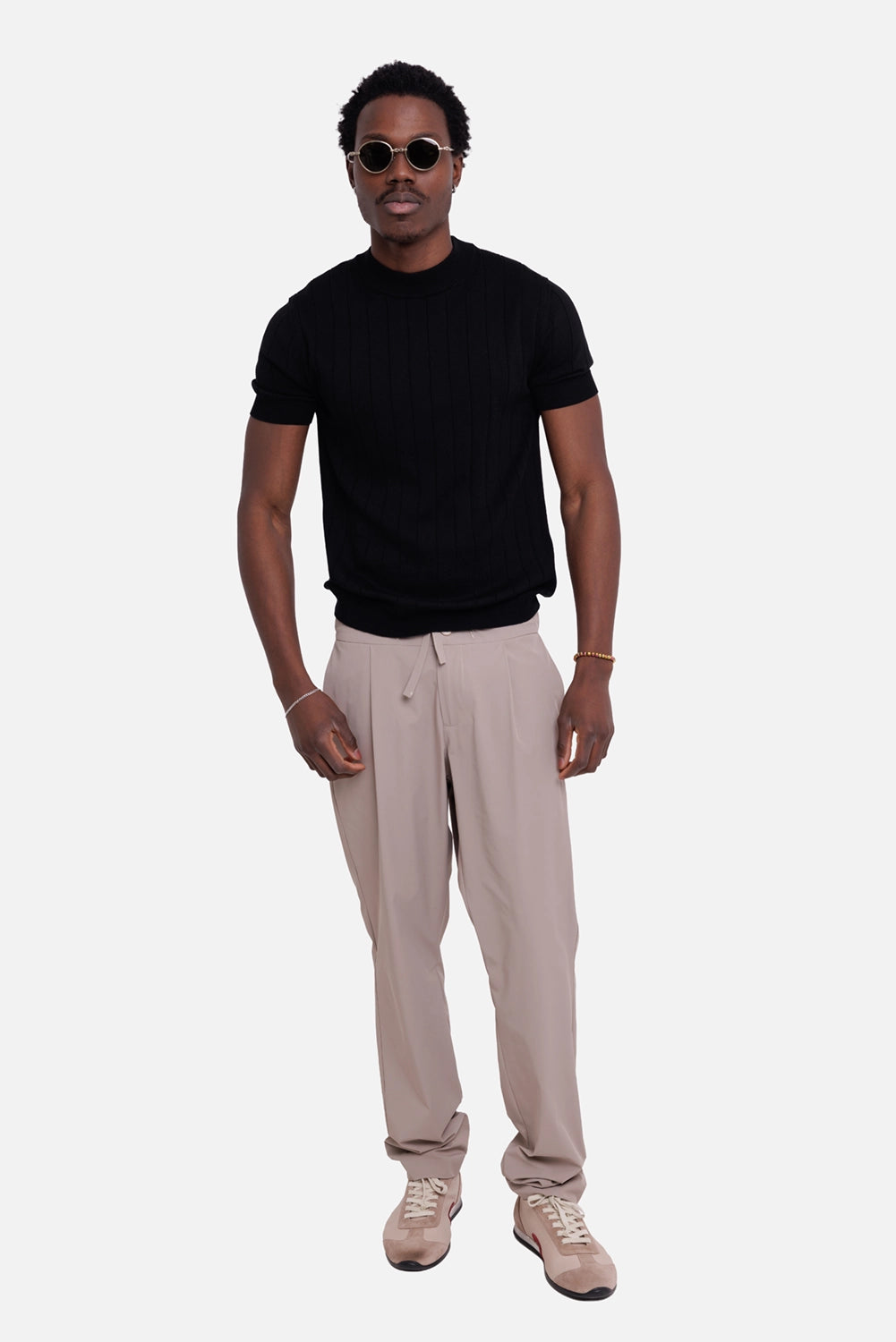 Gaëlle Paris men's trousers in fango, on-model full-length view, drawstring waist and tapered leg