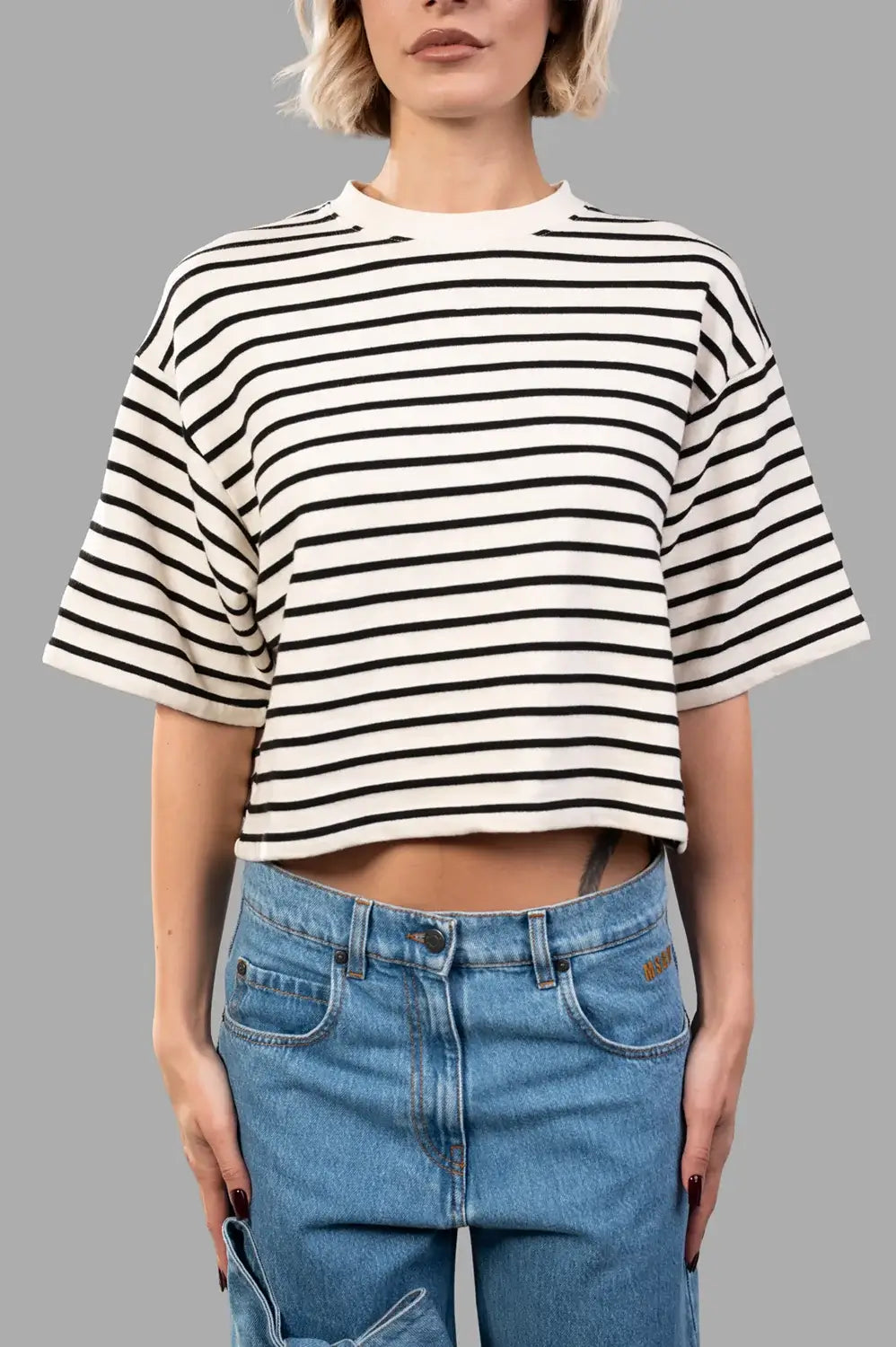 Front close‑up of striped French terry tee, showing texture and monogram detail