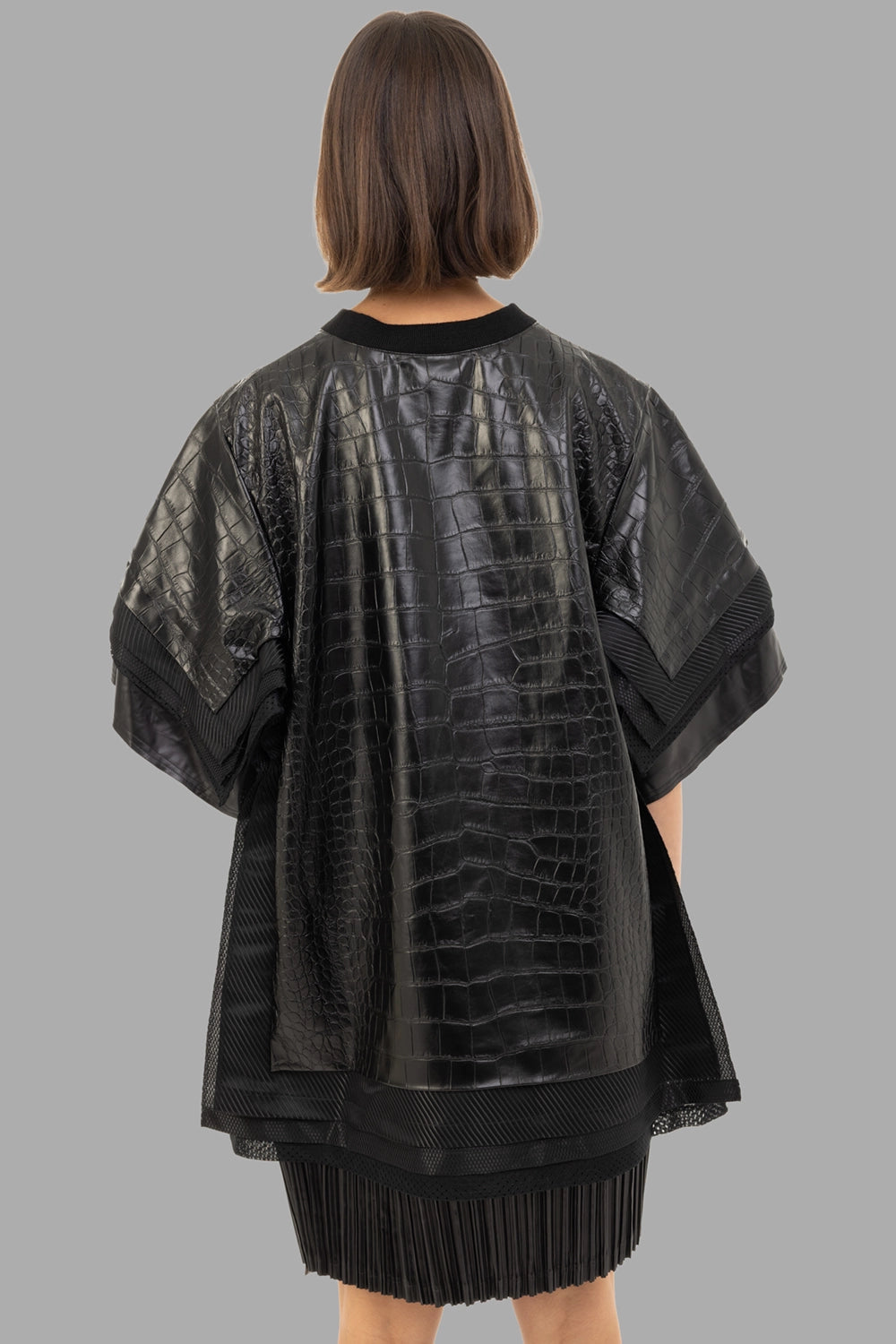 Junya Watanabe women’s faux-leather top in black, back view, full croc texture and tiered hem
