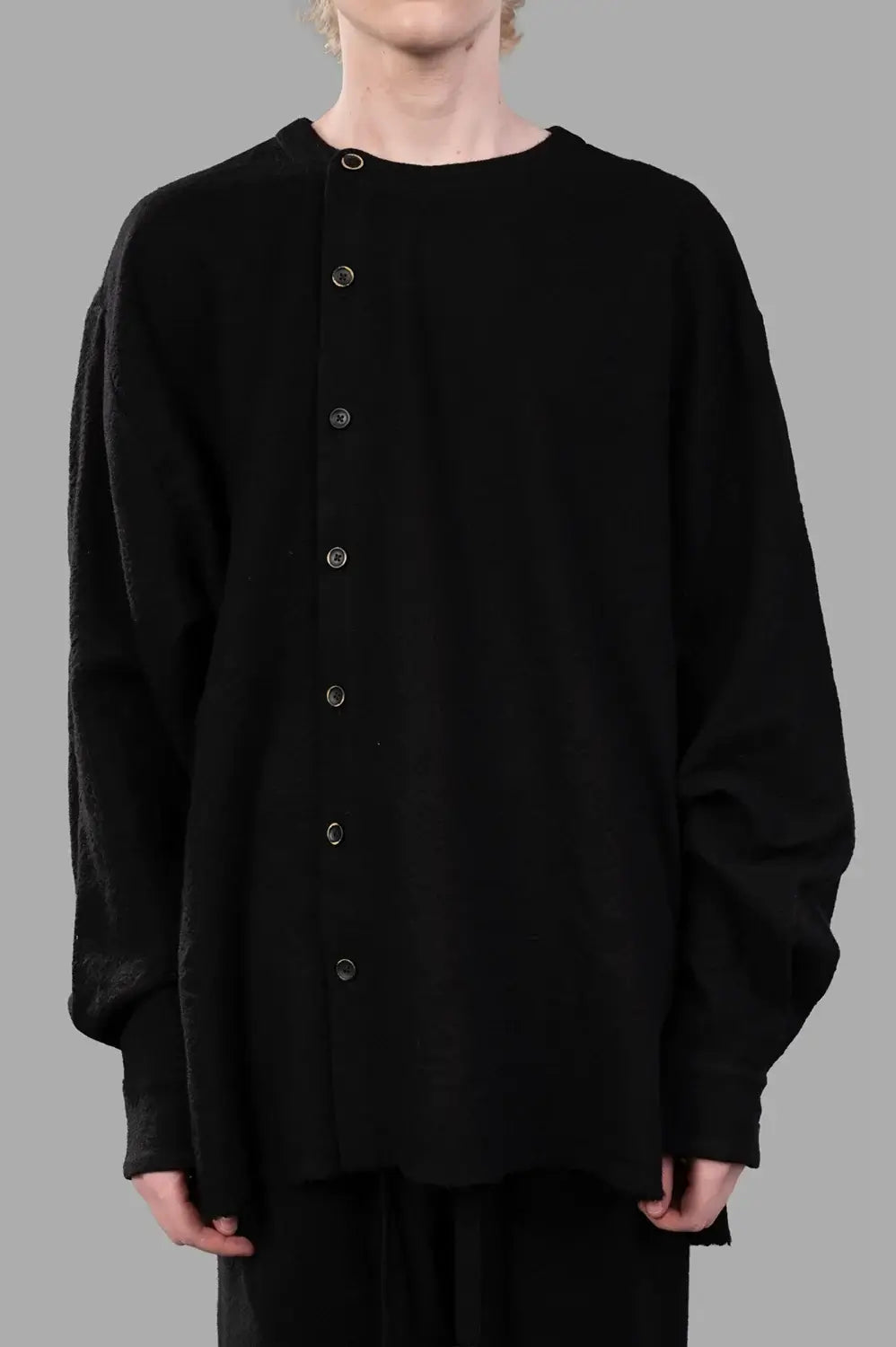 UMA WANG top in black, front view showing asymmetric button column and dropped shoulders
