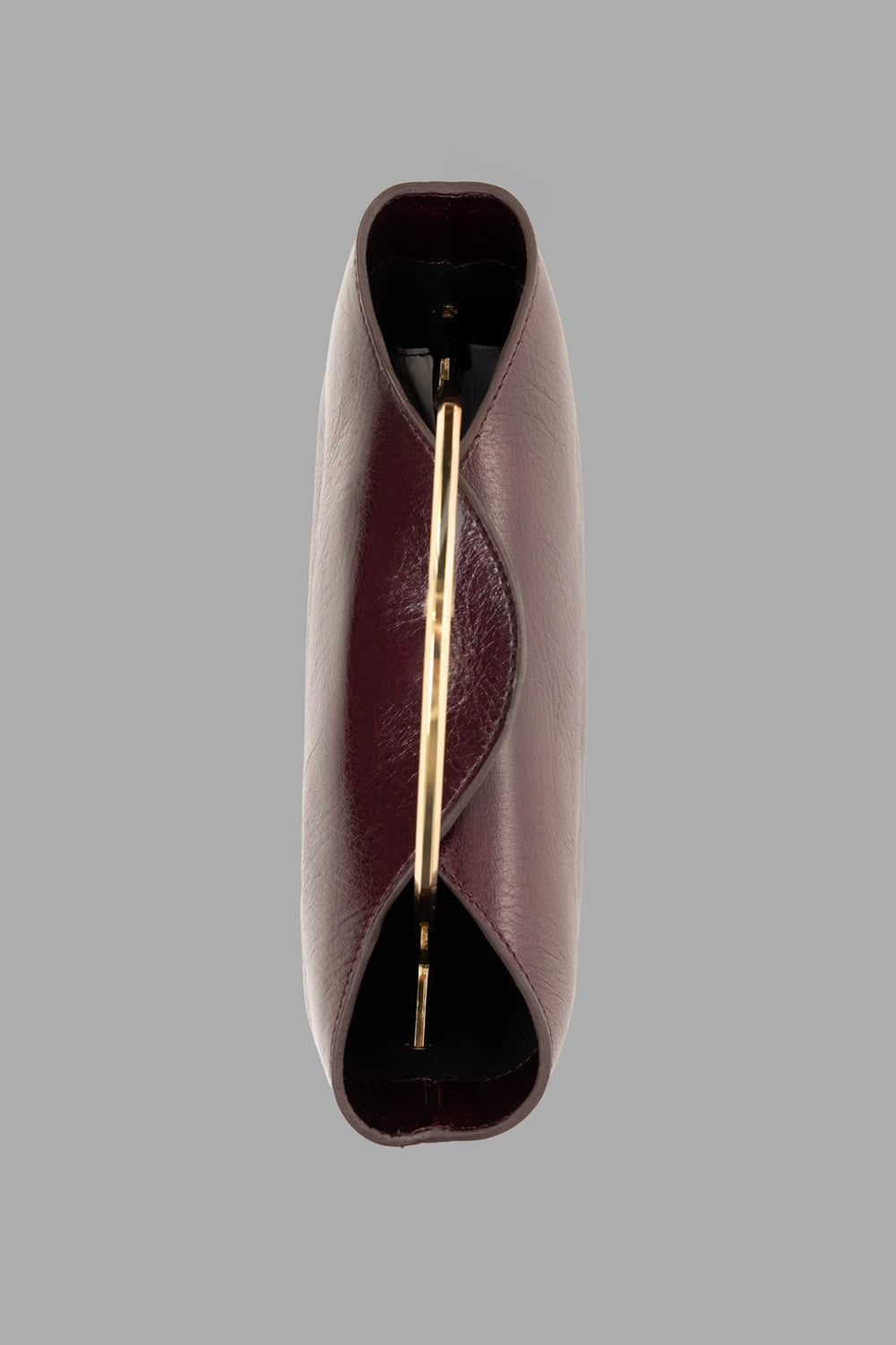 GentryPortofino women's top-handle bag in Borgogna, side view, slim gold arc handle and curved opening.