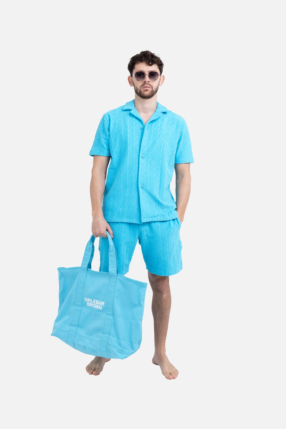 Orlebar Brown mens towelling shirt in Synth Blue, on-model full length, matching towelling shorts and Capri collar