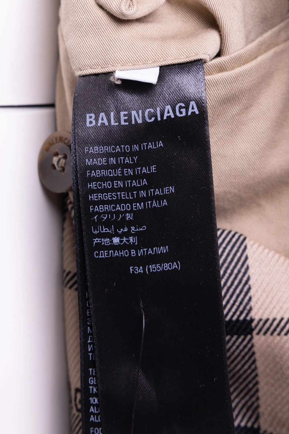Pre-owned Balenciaga women's trench coat in beige, label view, black brand tag showing size FR 34