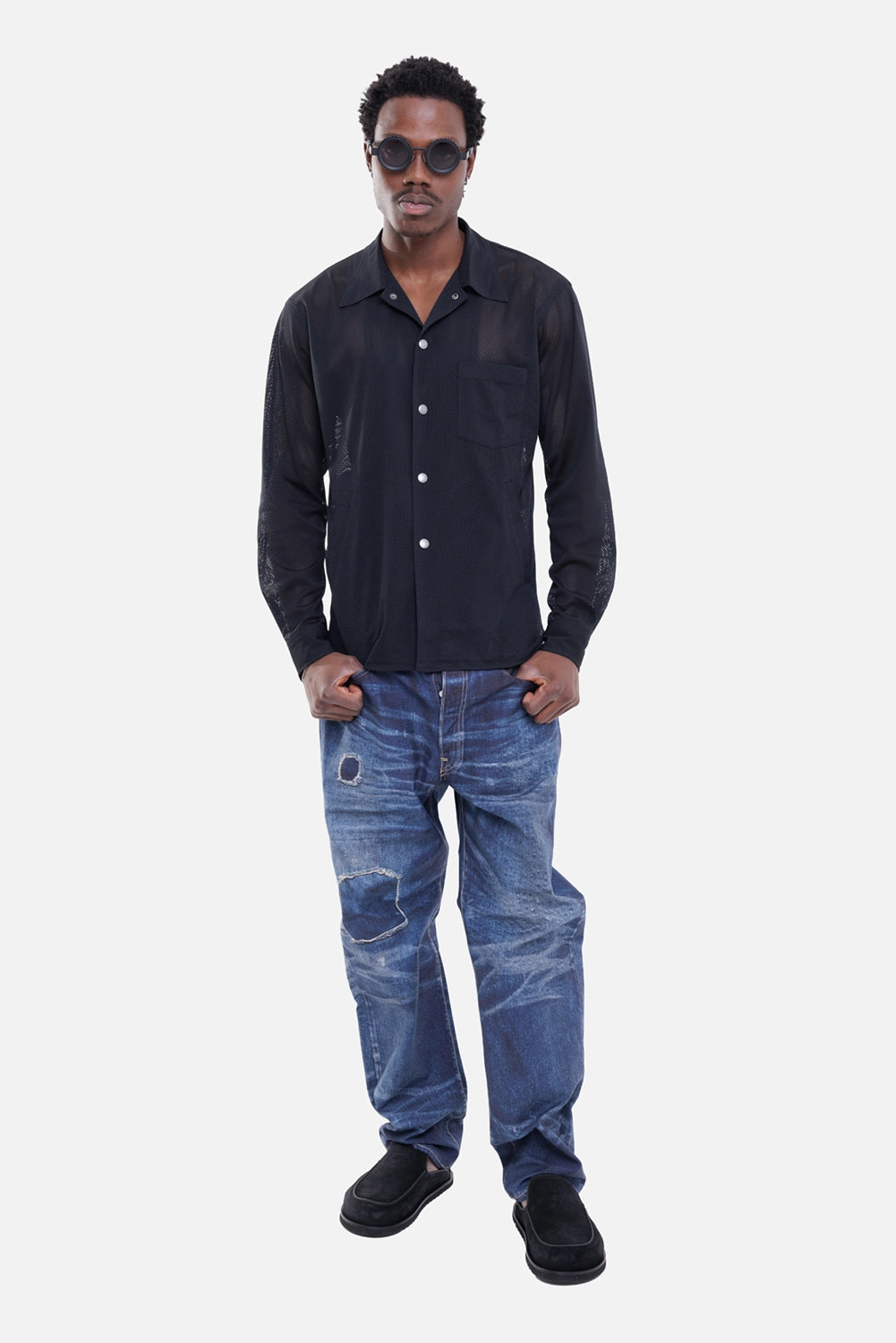 Junya Watanabe MAN men's jeans in indigo, on-model full-length view, faded print and cut-out patches