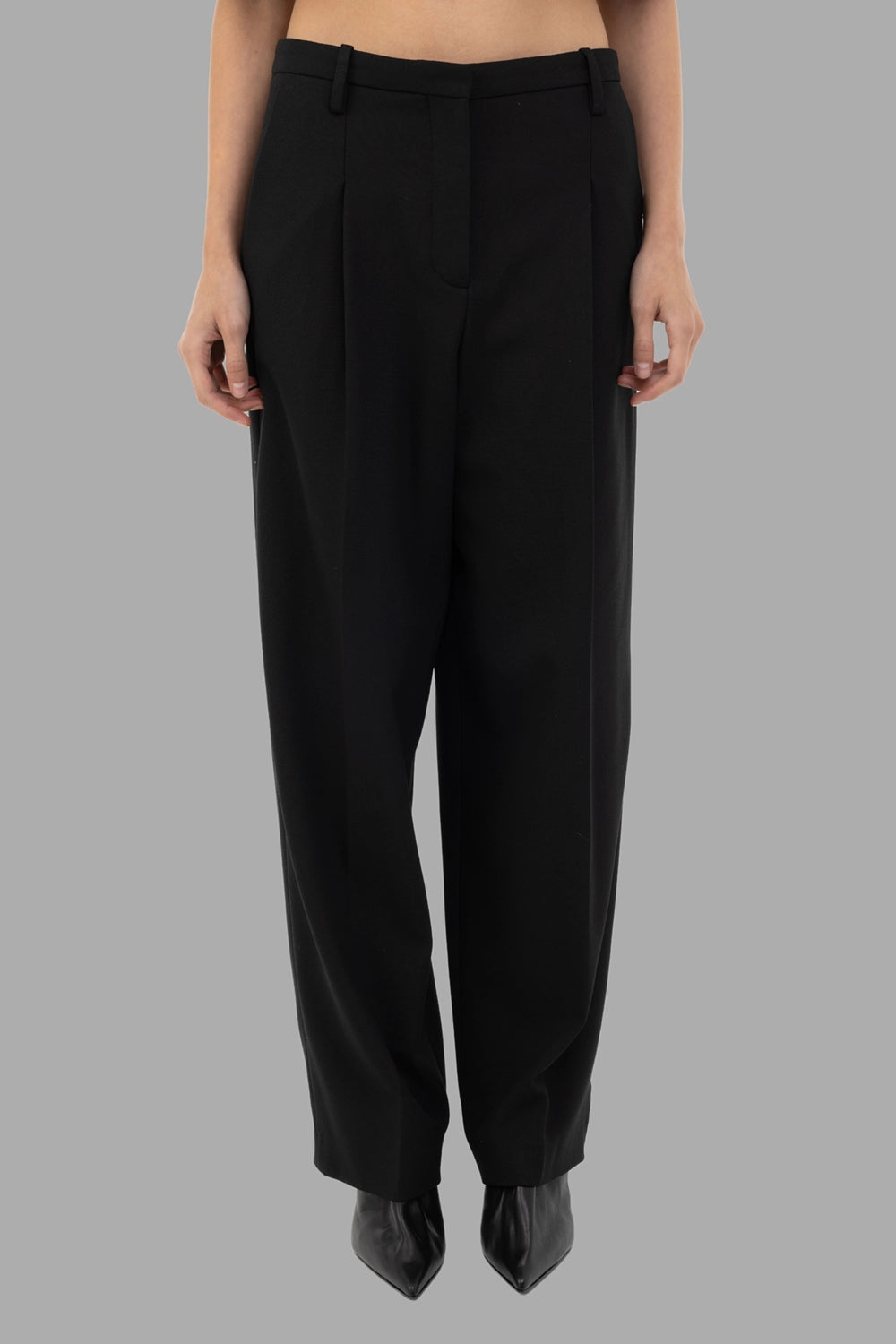 By Malene Birger women trousers in black, front view, pressed front creases and belt loops.