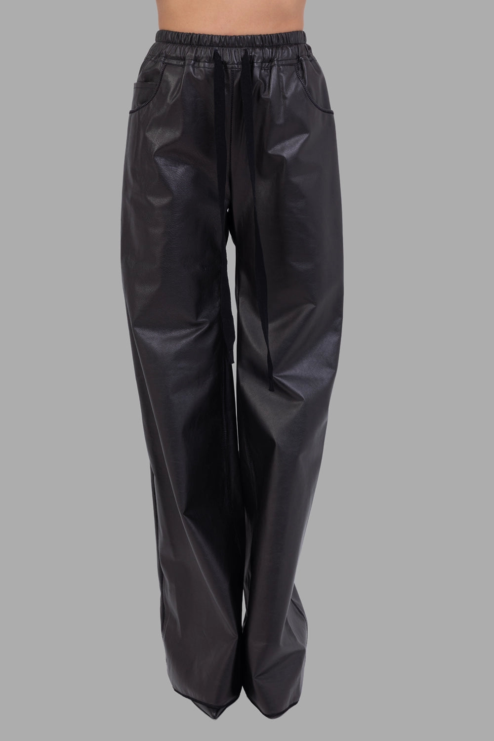 Isaac Sellam Experience women's leather trousers in black, front view, elasticated waist, long drawstrings and side pockets.