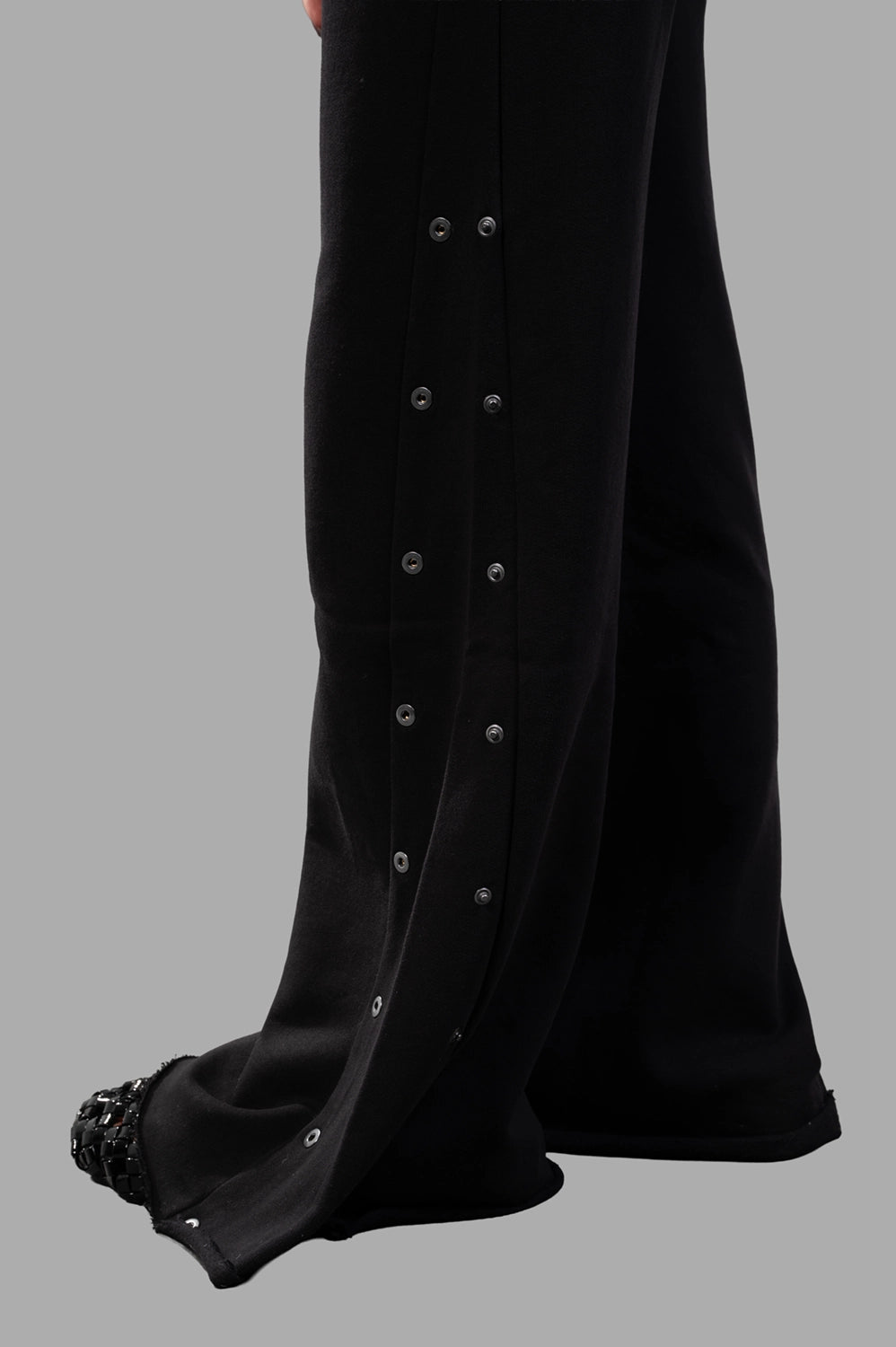 Sehnsucht Atelier wide-leg trousers in black, hardware close-up of double row metal snaps at side seam