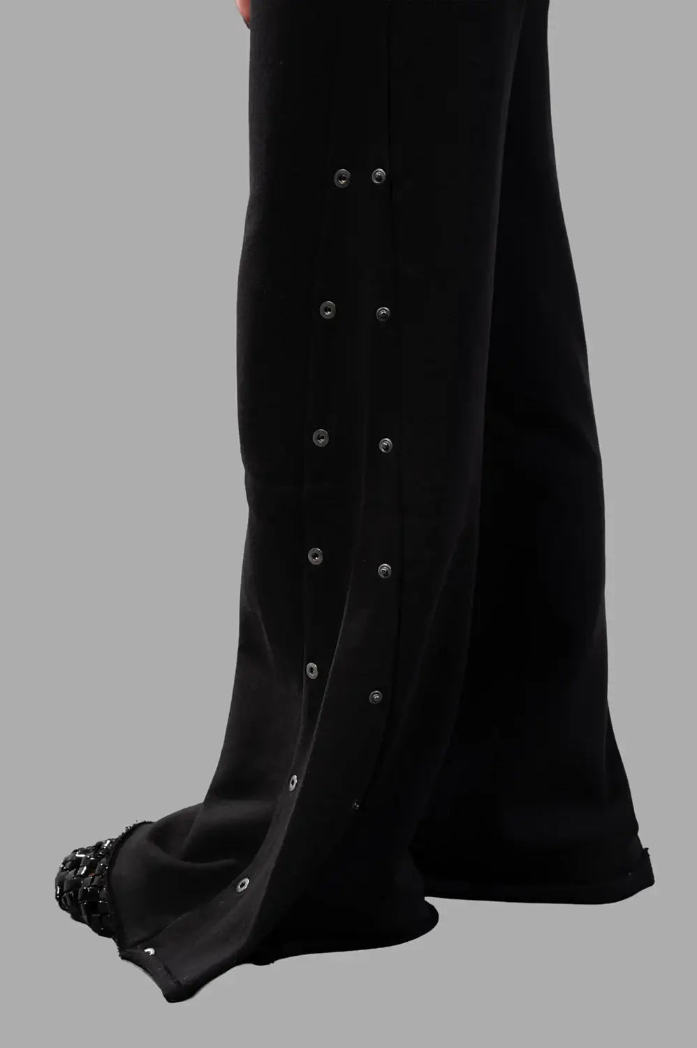 Sehnsucht Atelier wide-leg trousers in black, hardware close-up of double row metal snaps at side seam