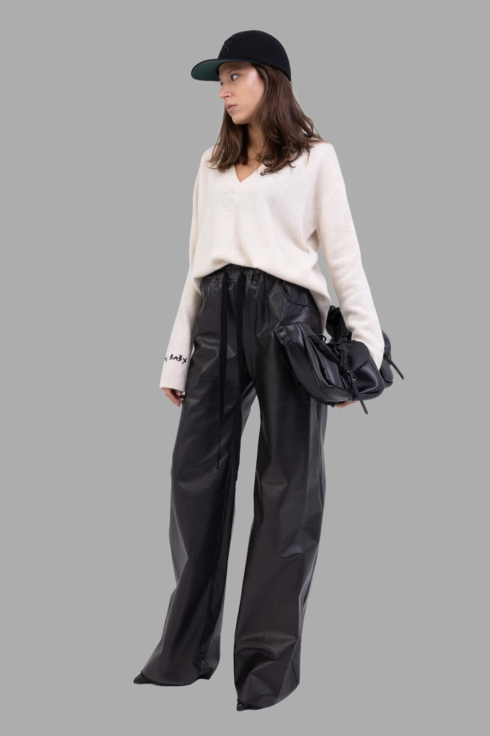 Isaac Sellam Experience women's leather trousers in black, on-model full length, wide leg, elastic waist with drawstrings.