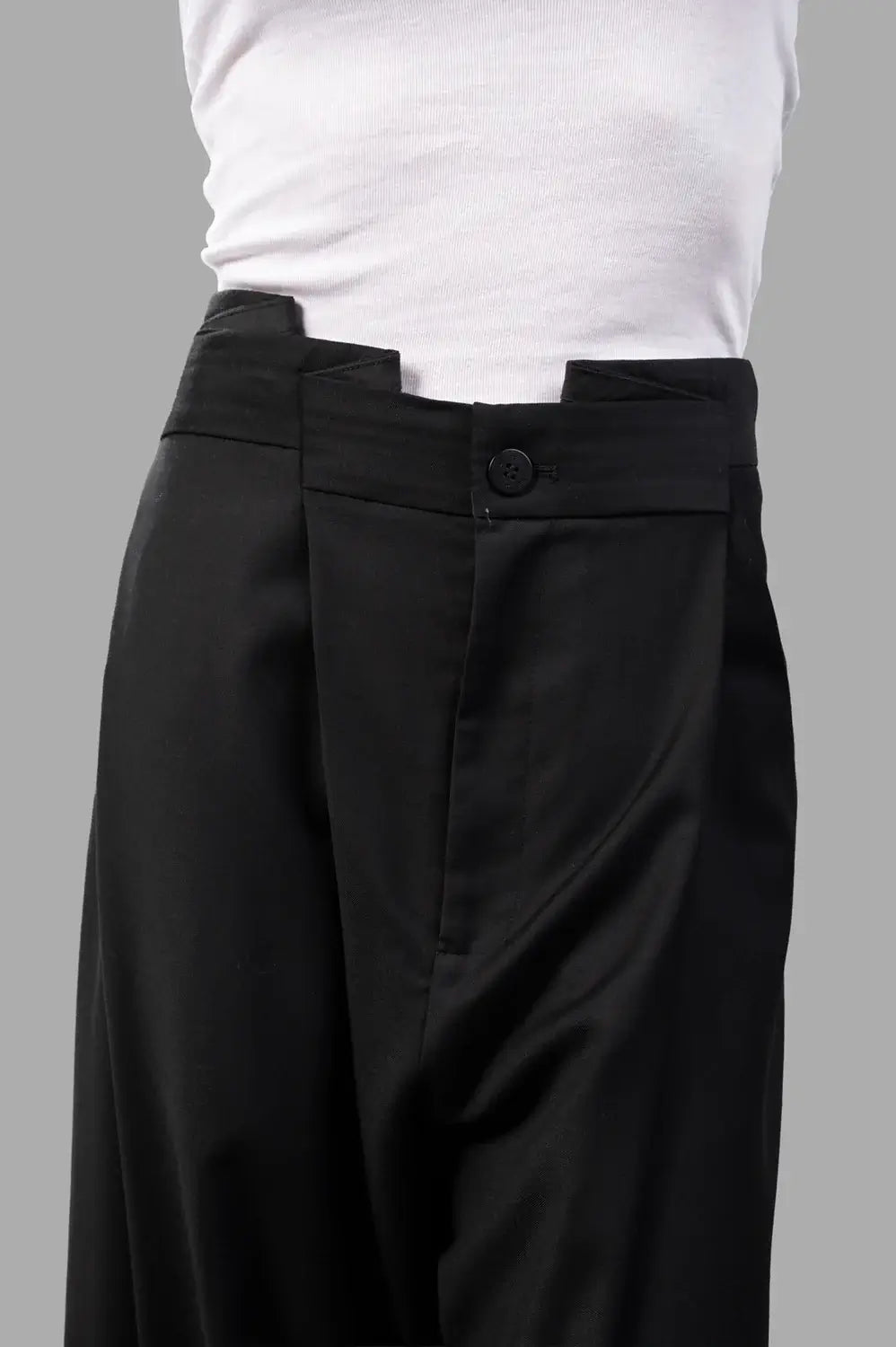 Natasha Zinko trousers in black wool, back view, crease detailing and soft wide leg drape
