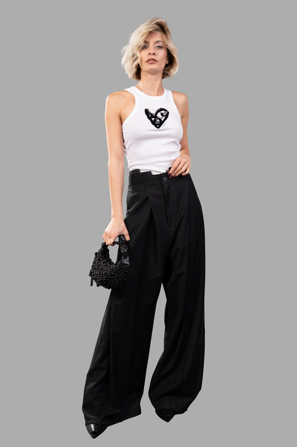 Natasha Zinko trousers in black wool, on‑model full length, draped high waist fold and wide-leg silhouette