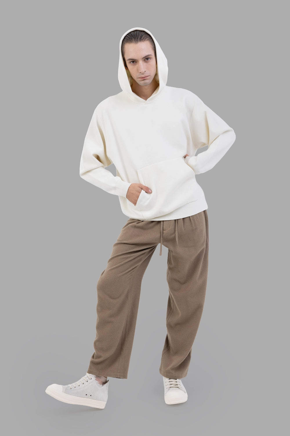 ATTACHMENT trousers in camel, full length on model, relaxed wide tapered leg