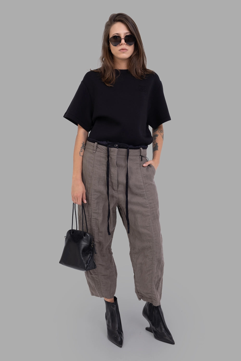 Masnada women trousers in Dust, on-model full length, paperbag-style waist with drawstring and paneled legs.