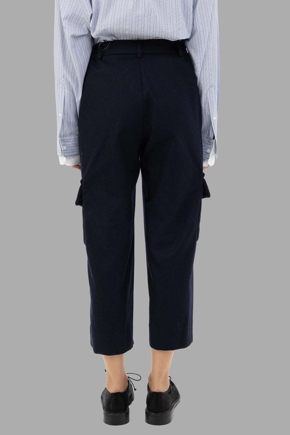 Comme des Garçons women cargo trousers in navy, back view, clean lines and cropped hem.