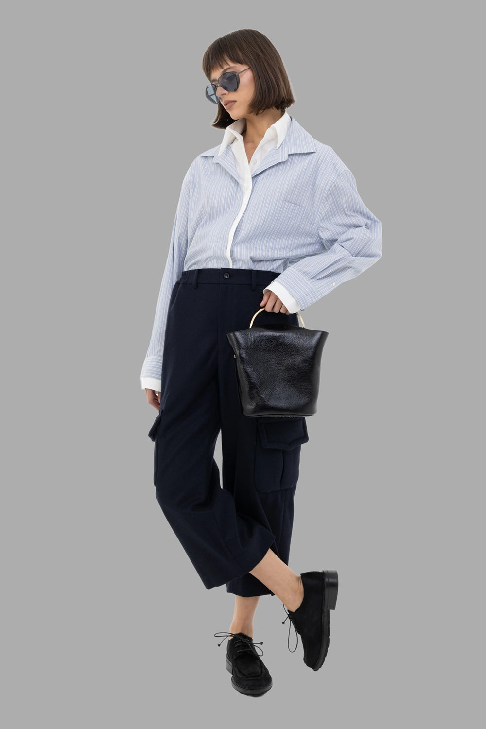 Comme des Garçons women cargo trousers in navy, on-model full length, cropped leg and flap cargo pockets.