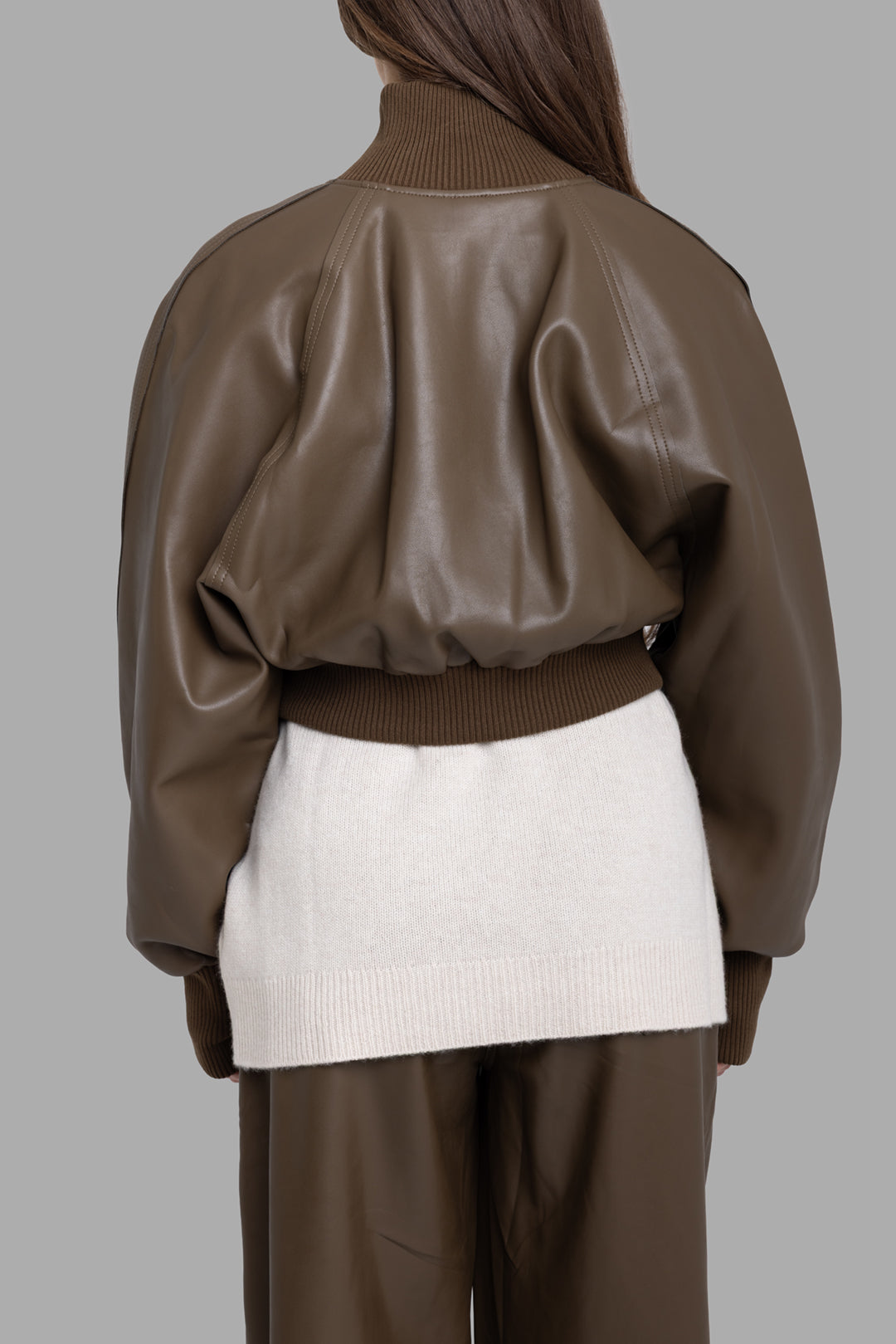 Norma Kamali women's bark vegan leather bomber jacket, back view, relaxed volume with ribbed hem and cuffs.