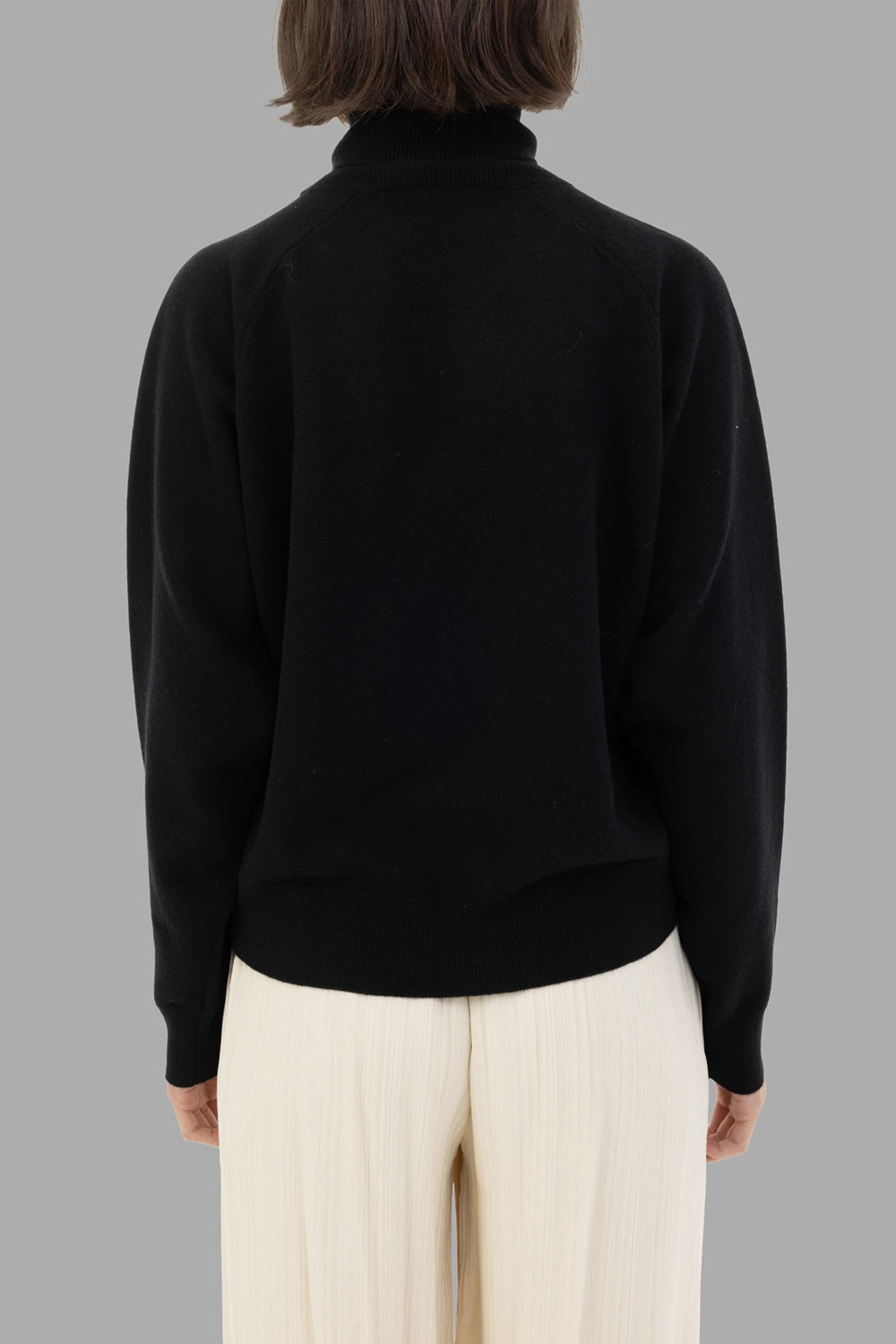 GentryPortofino women's turtleneck sweater in Nero, back view, raglan shoulder lines and ribbed hem.