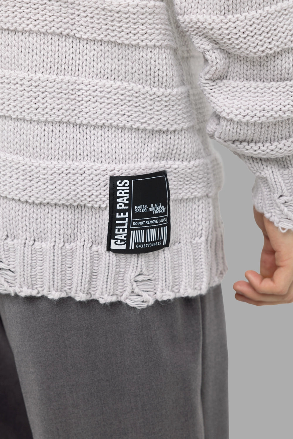 Gaëlle Paris men’s turtleneck sweater in off-white, hem logo patch detail with barcode graphic and frayed ribbing