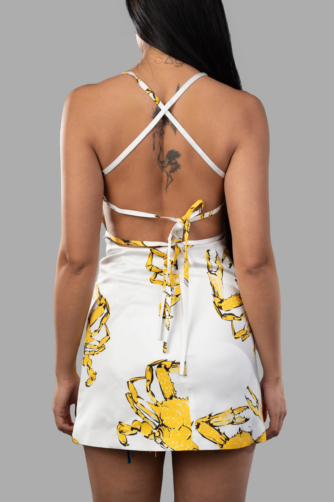 **MSGM Crab-print Dress showcasing criss-cross back design with vibrant crab graphics and square halterneck. Stylish summer piece.**