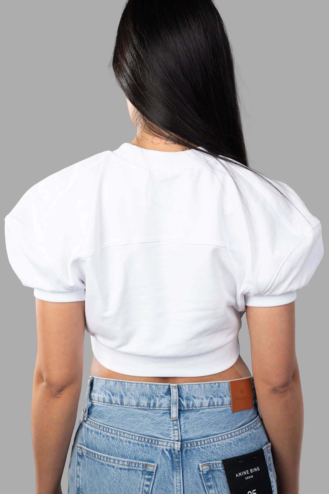 Vivienne Westwood Cropped Football Sweatshirt featuring voluminous shoulders and ribbed details, styled on a model from the back.