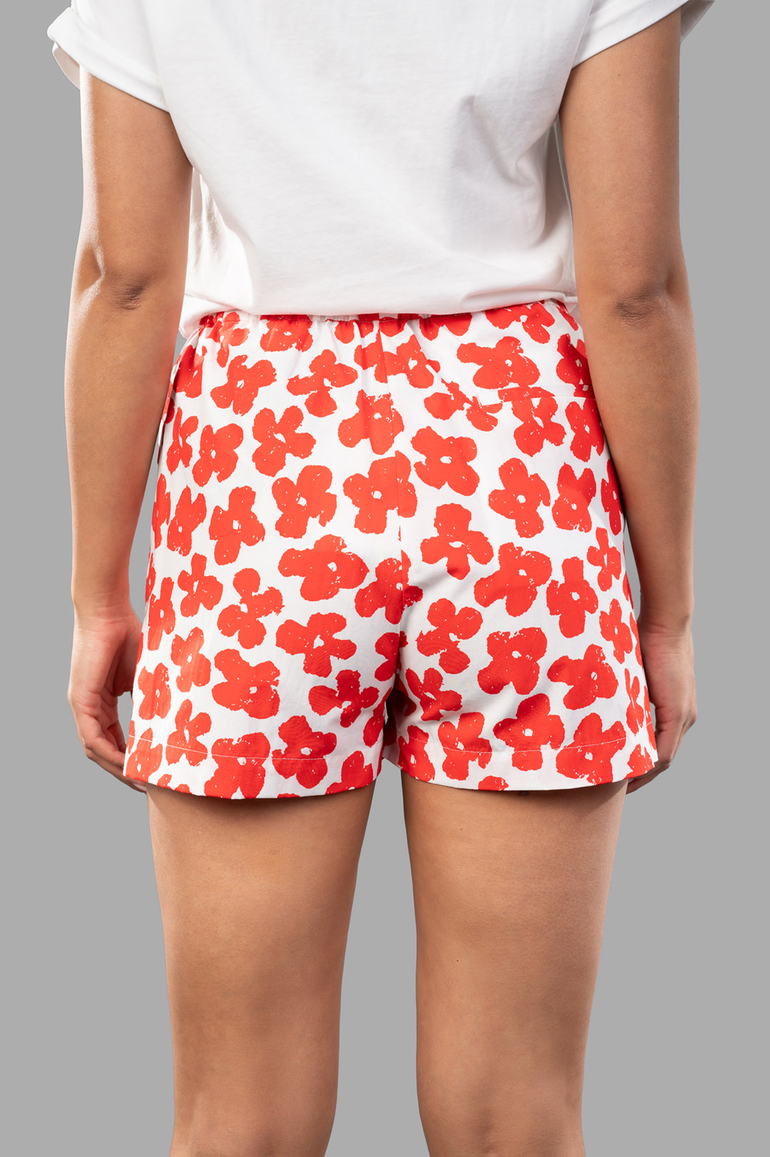 MSGM Floral-print Shorts showcasing a vibrant red flower design, featuring an elasticated waistband and back view.