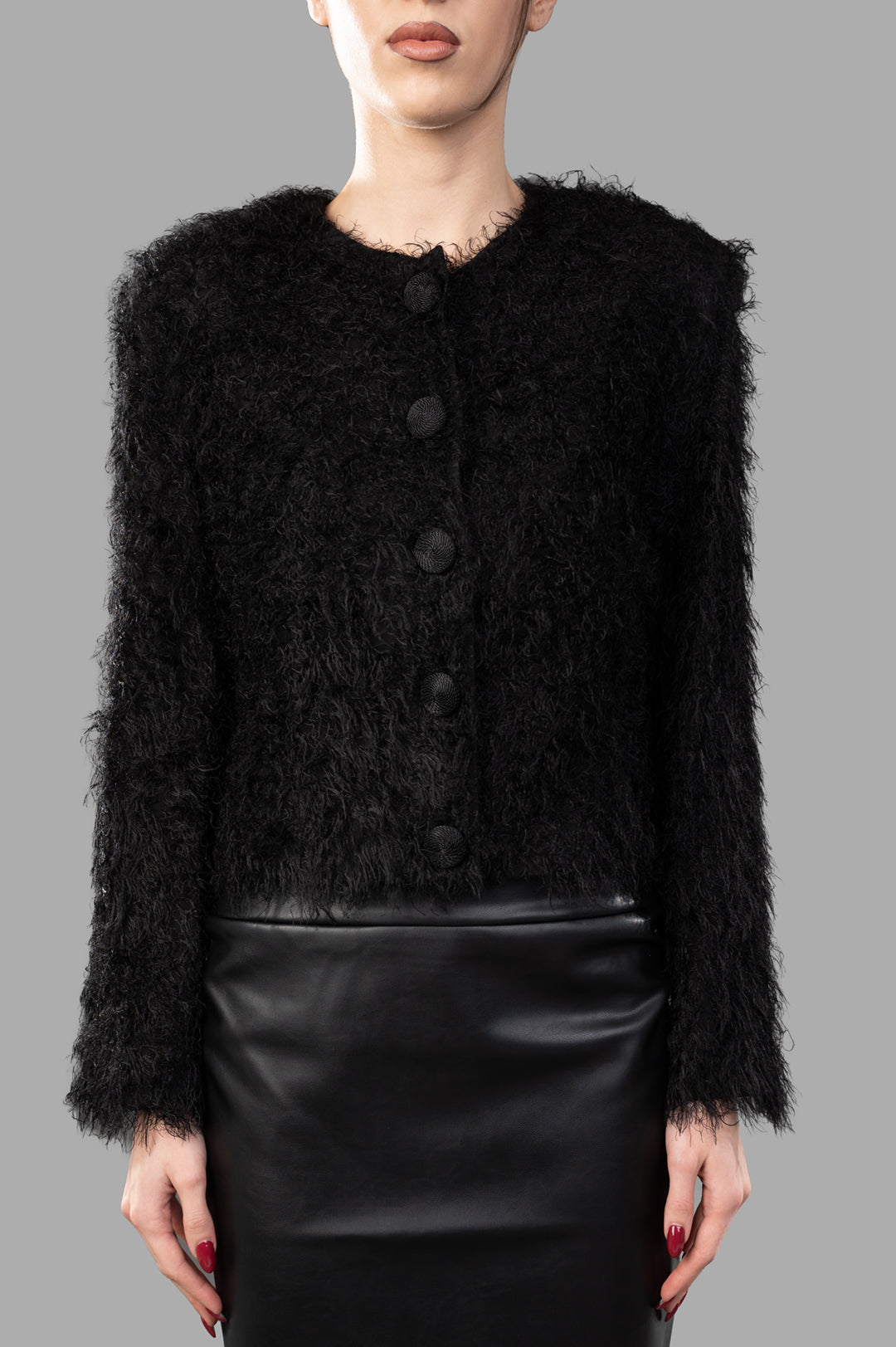 By Malene Birger Stephania Cardigan in black, featuring a fluffy texture, round neck, and button closures, modeled front.