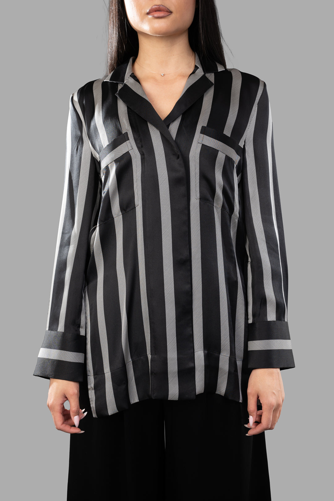Anine Bing Lynette Shirt displayed on a model, showcasing the black herringbone stripe pattern and oversized silhouette.