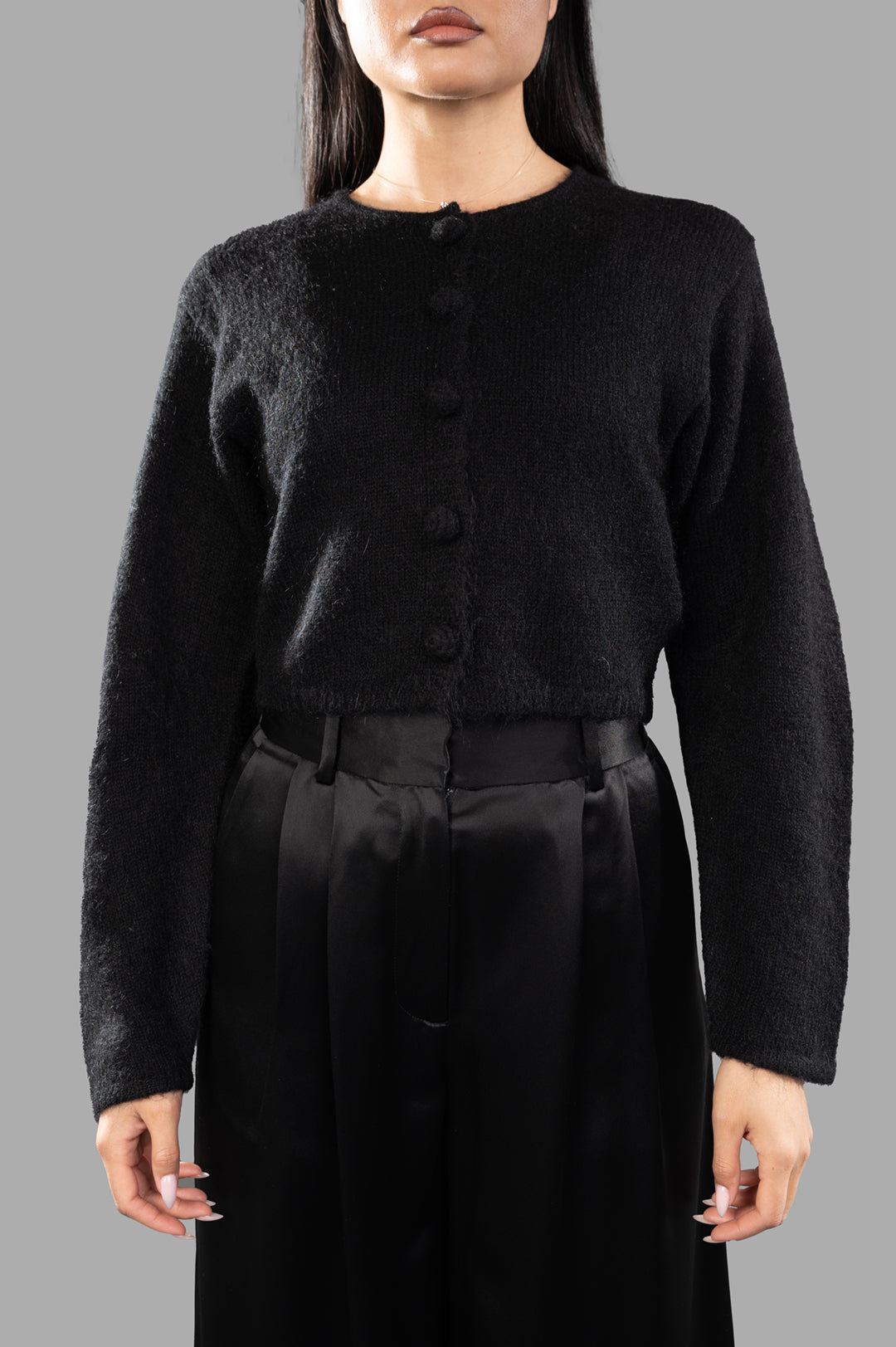 By Malene Birger Zharea Wool-blend Cardigan in black, featuring a cropped design, button closure, and soft texture, worn by.