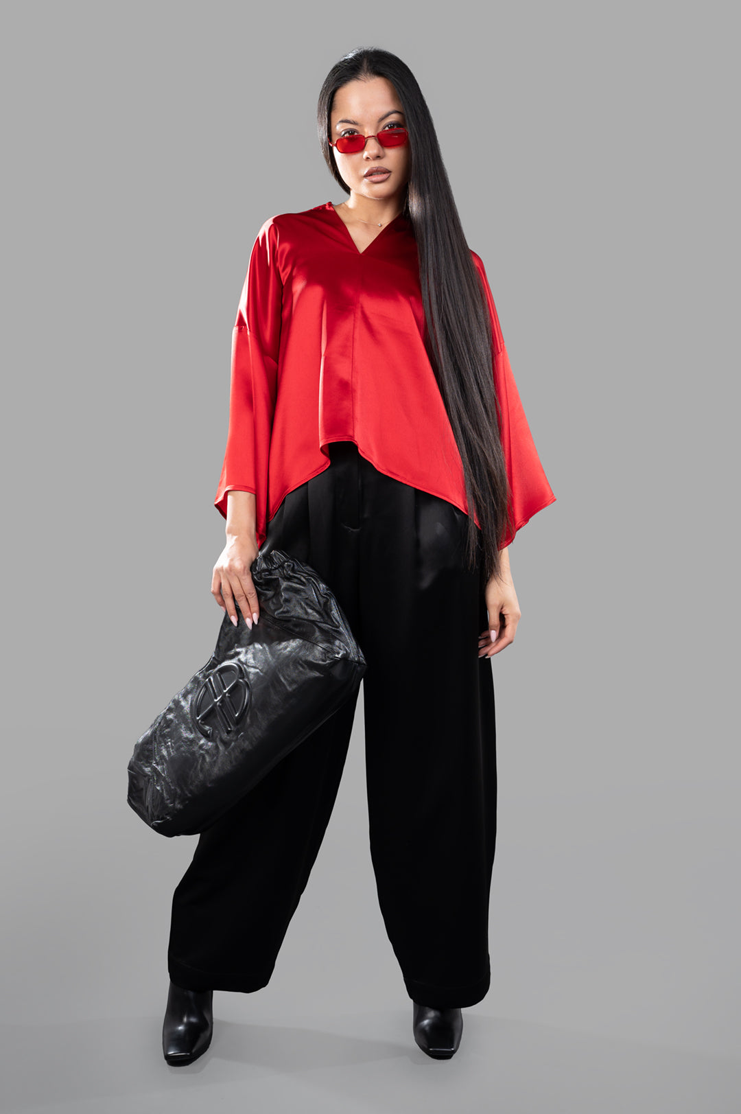 By Malene Birger Cicie Blouse in red satin, front view on model, showcasing dropped shoulders and wide-cropped sleeves.