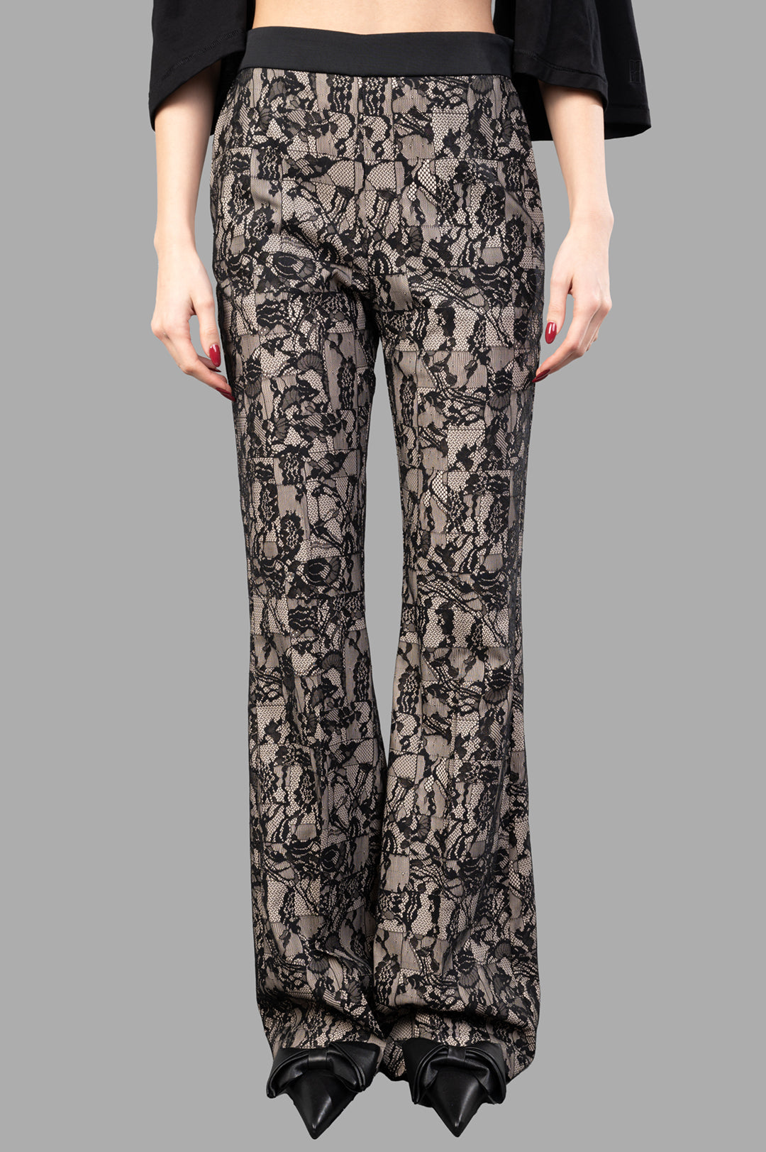 Joseph Patchwork Lace Trousers displayed on model, featuring a black patchwork lace design, slight flare cut, and smooth.