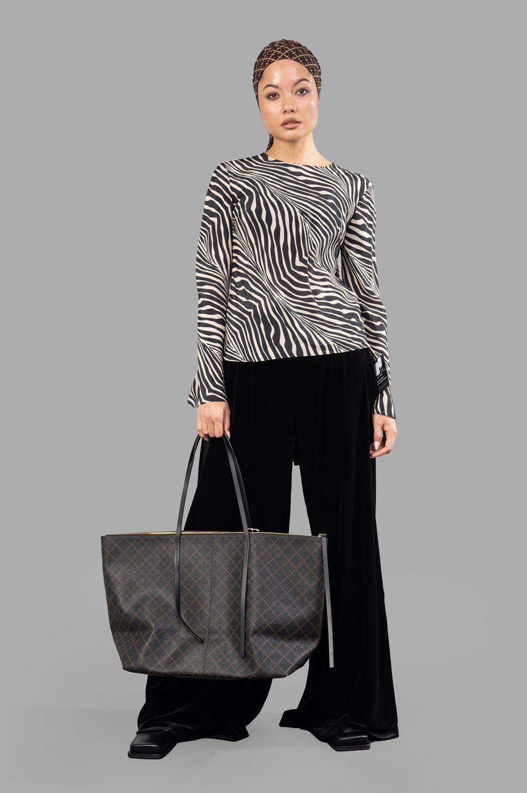 By Malene Birger Pricilla Top in zebra print, front view on model, featuring flared sleeves and slim silhouette.